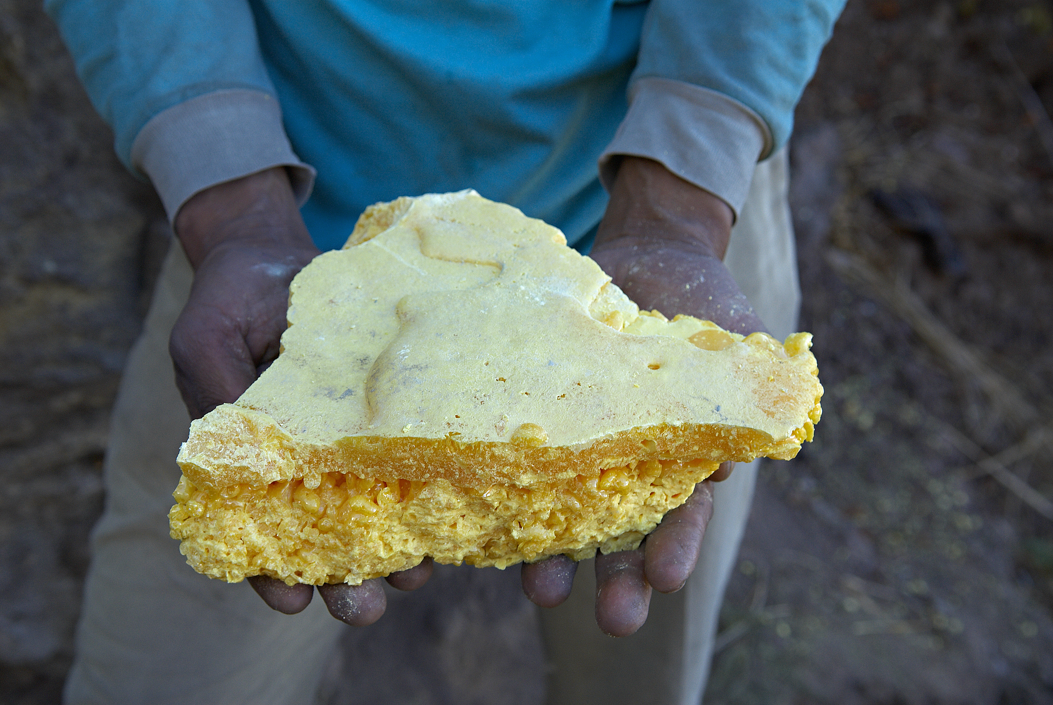 man holding sulphur, close-up