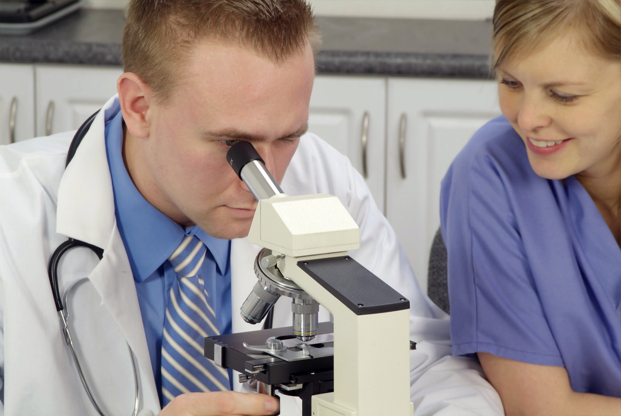 doctors looking in microscope