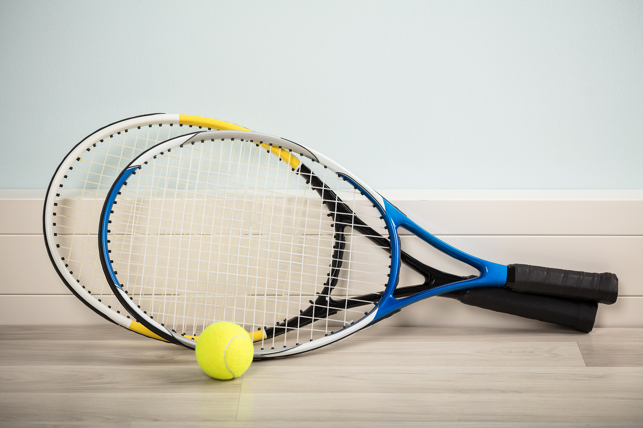 pair of rackets and a ball