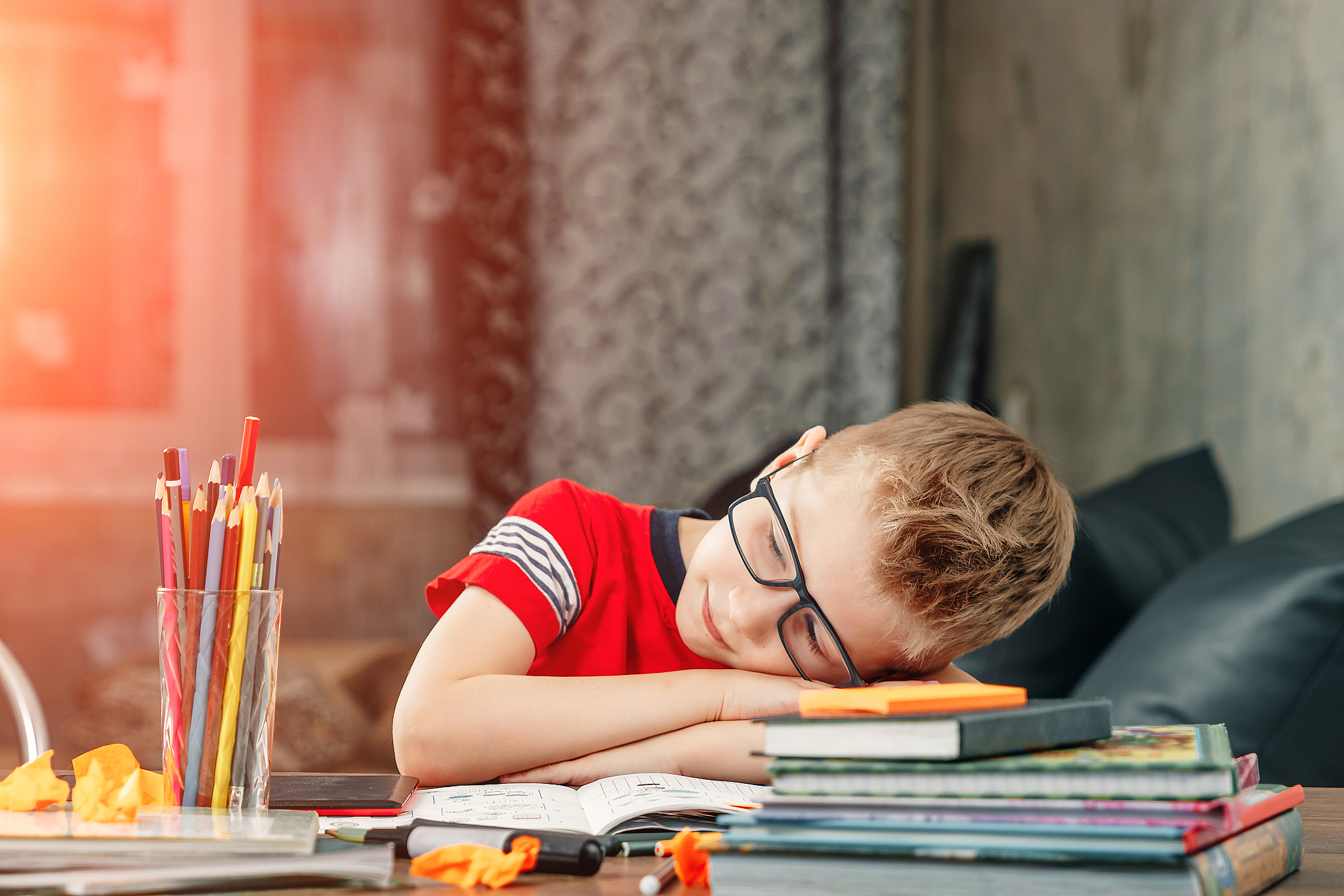 the little boy is sad, bored to do homework.