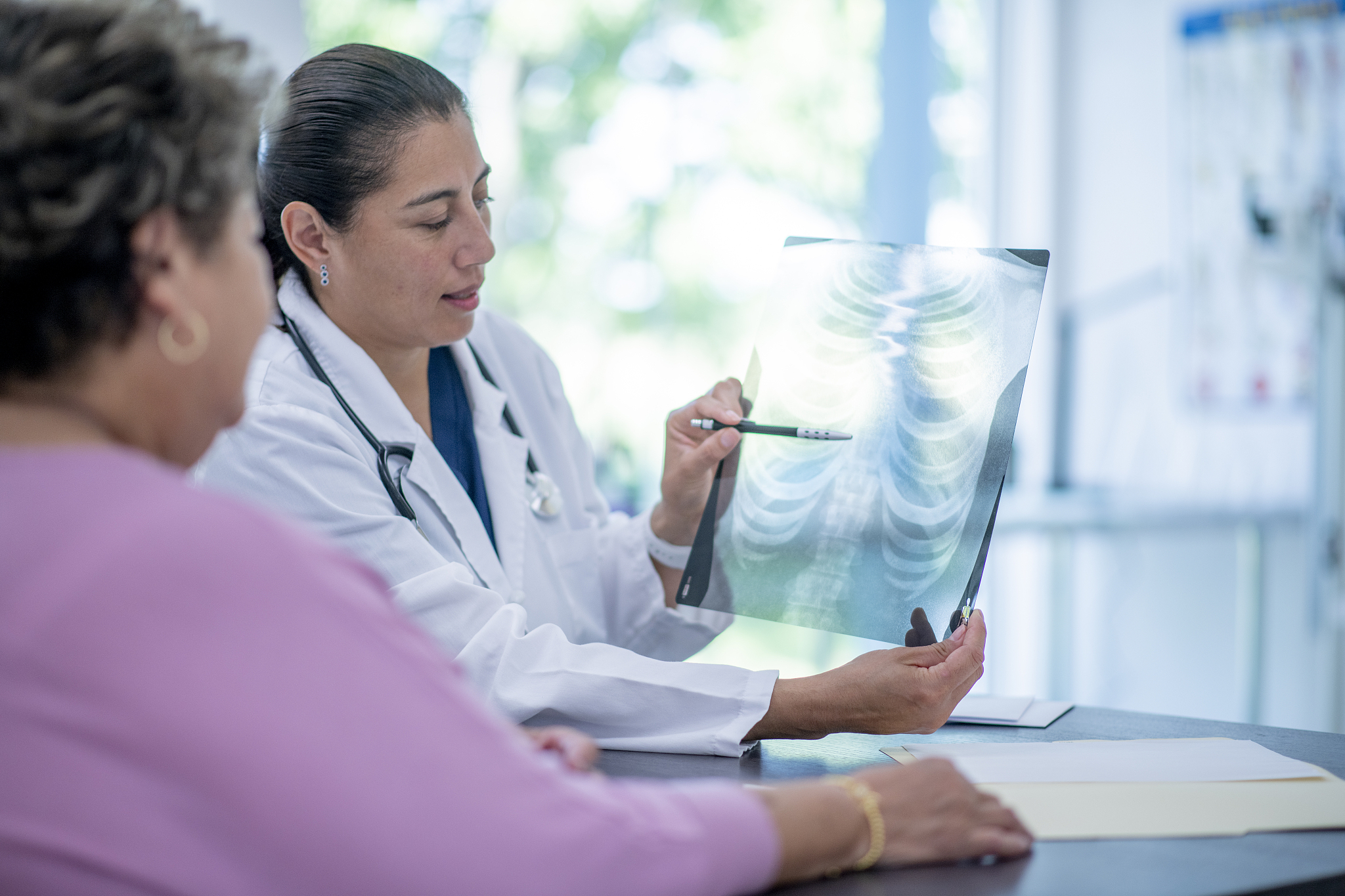 elderly woman visits her doctor stock photo