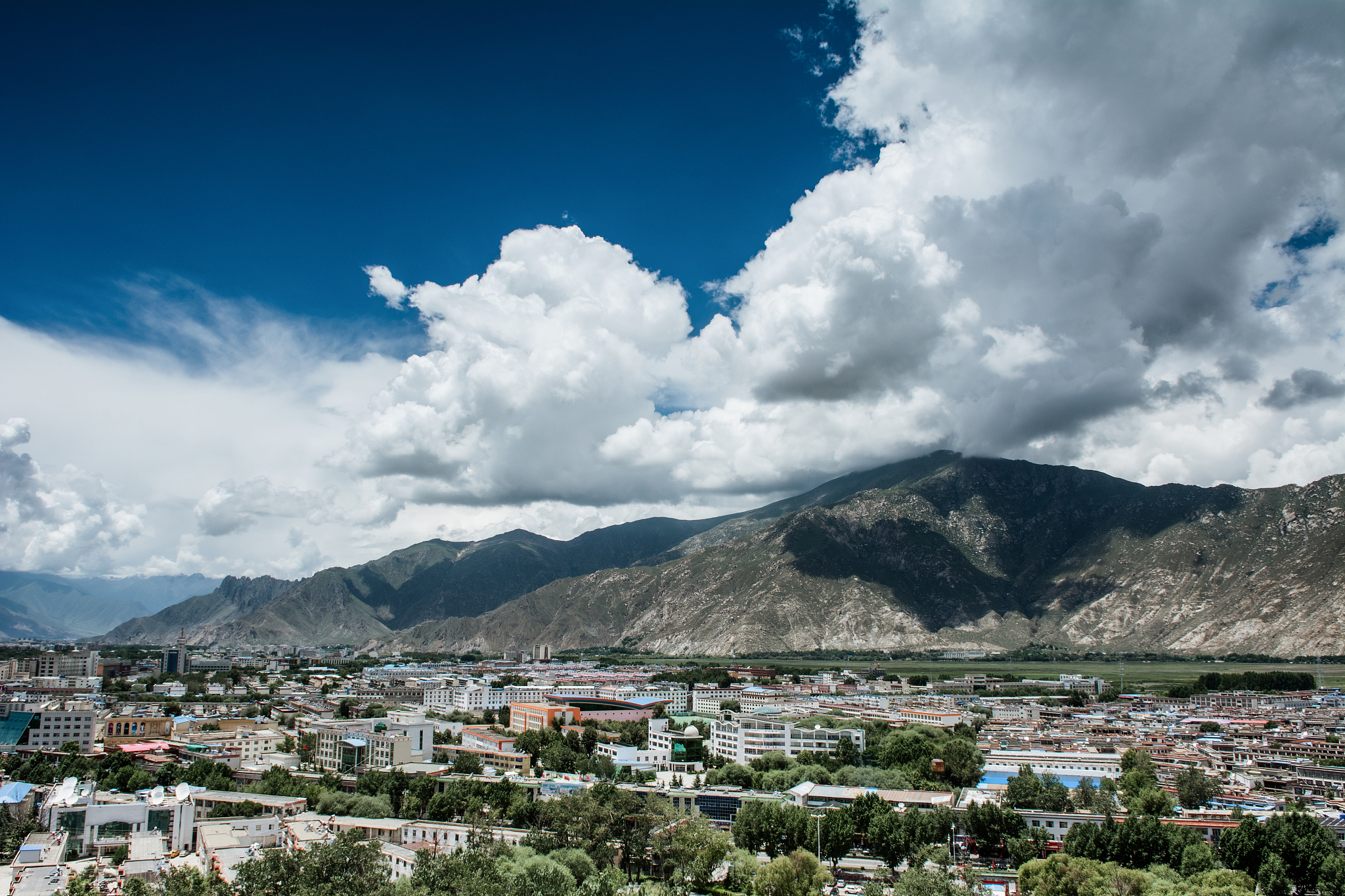 blue sky and white clouds over the city of lhasa, tibet
