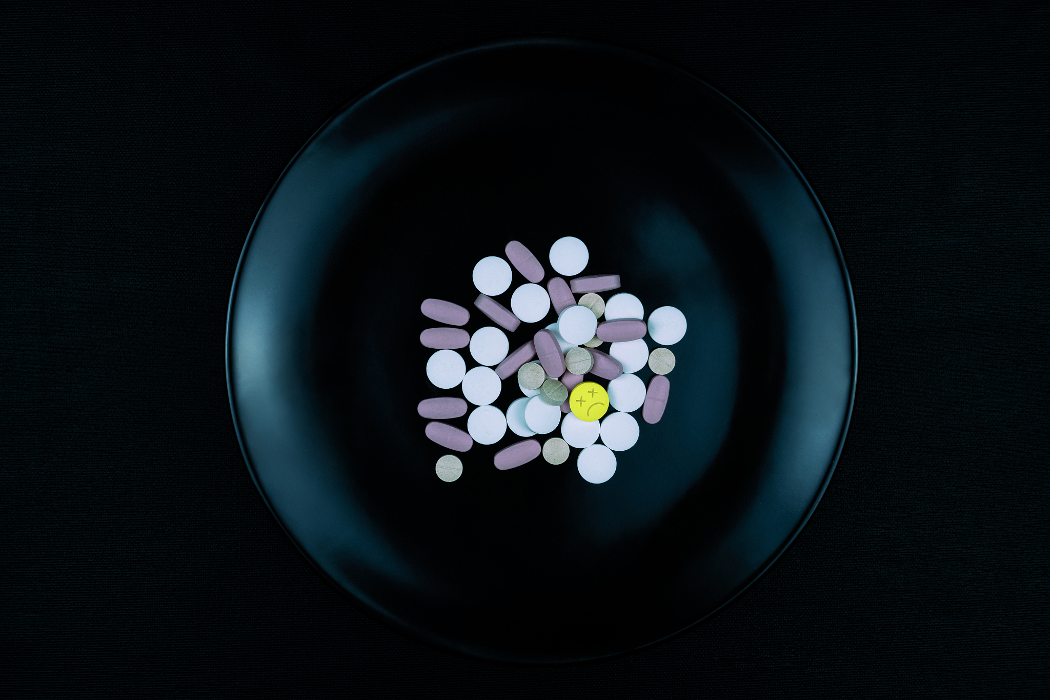 black plate full of pills one means death