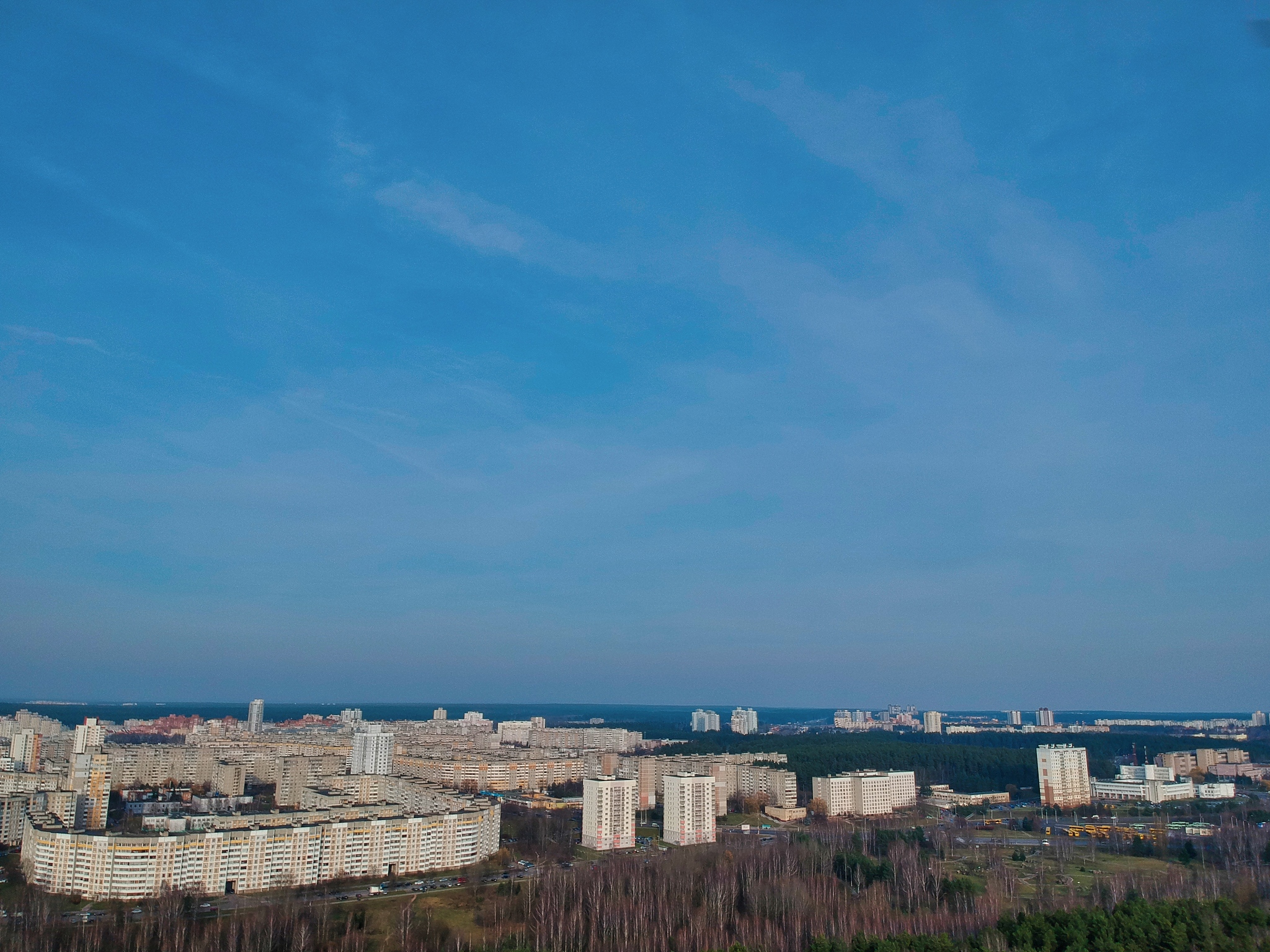 high angle view of buildings and sea against blue sky