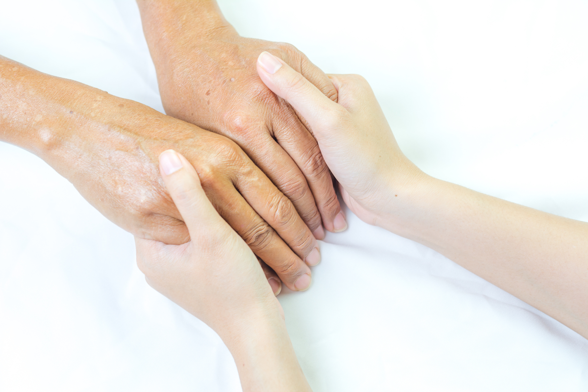 asian senior and asian young holding hands.