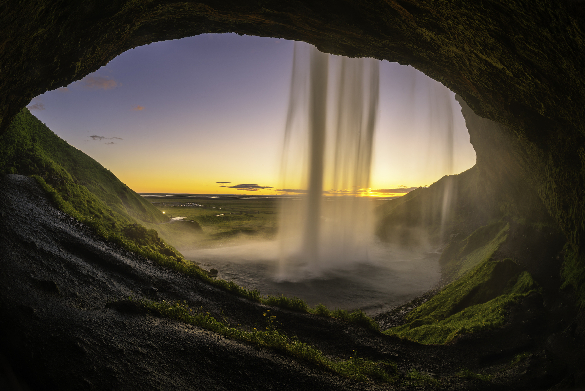 sunset scene of inside seljalandsfoss waterfall, iceland