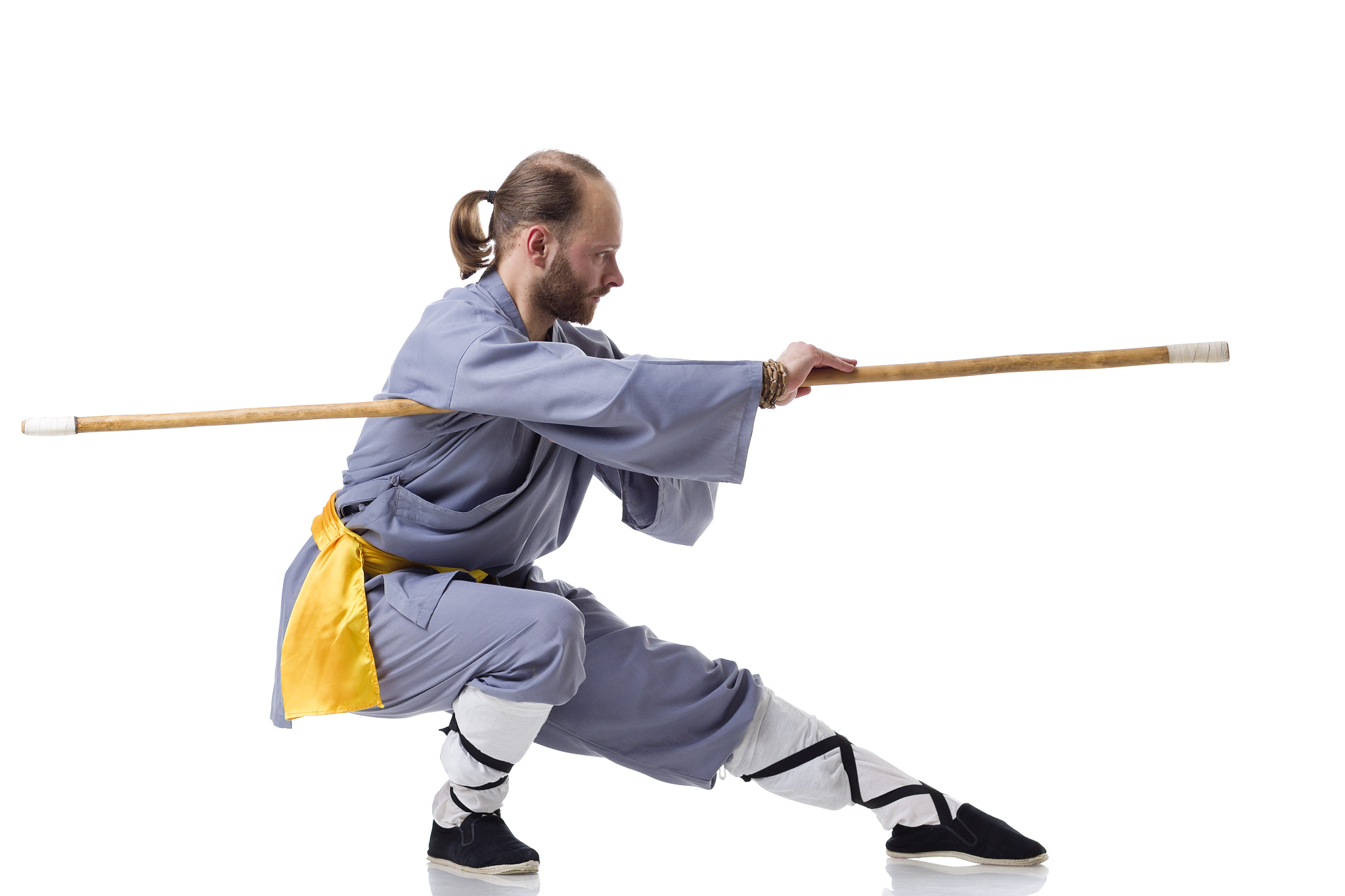 kung fu fighting position with wushu cudgel isolated on white