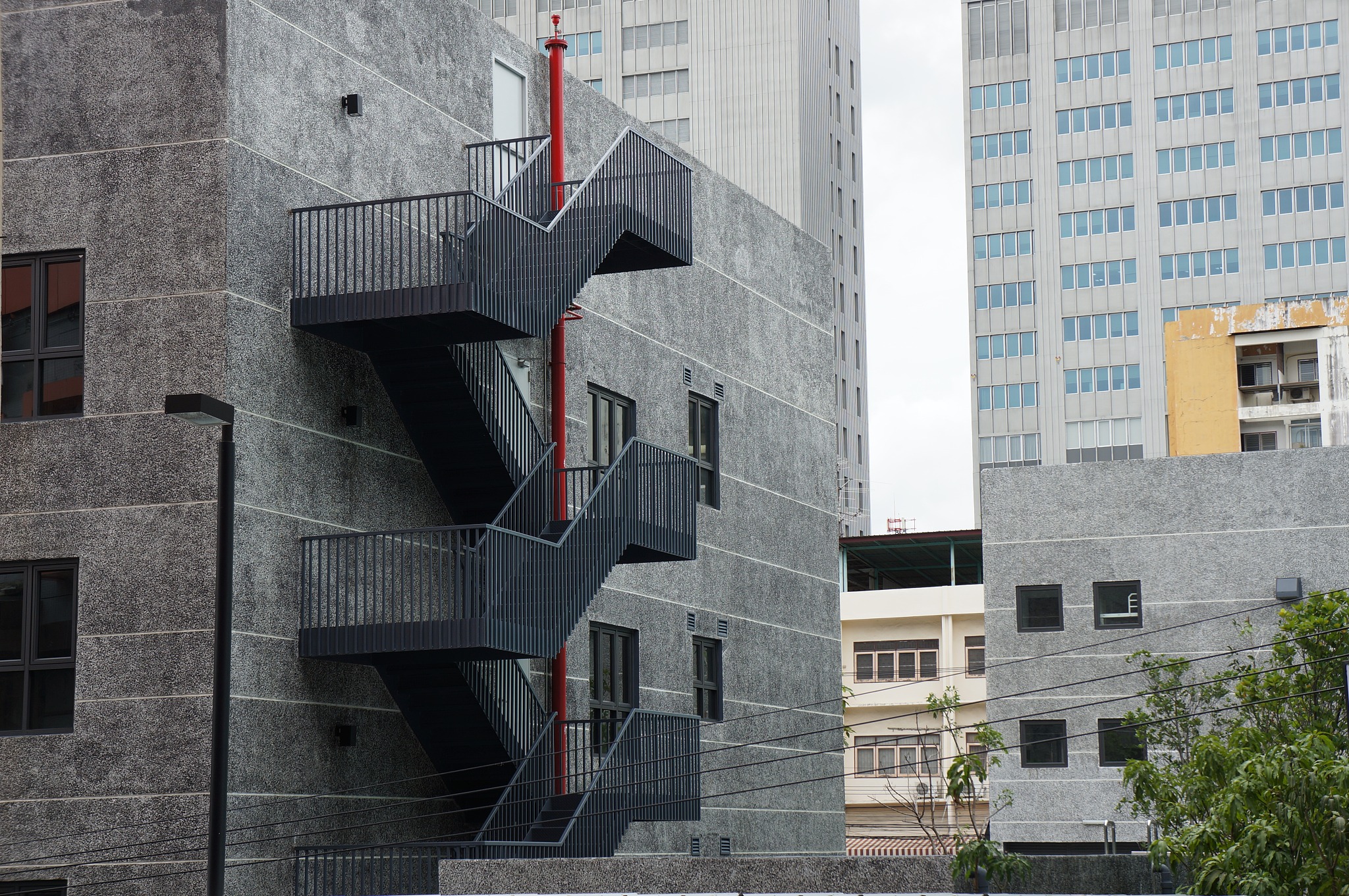fire escape stairs on the building wall in bangkok city