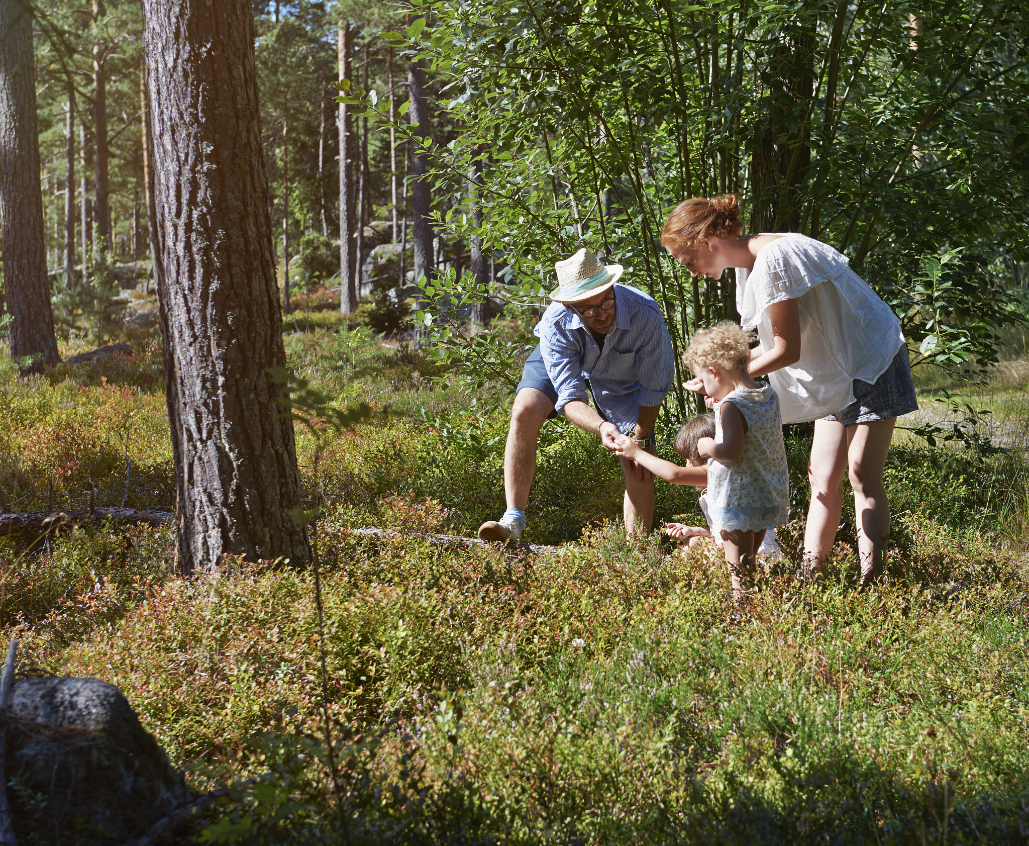 parents and daughters exploring in forest