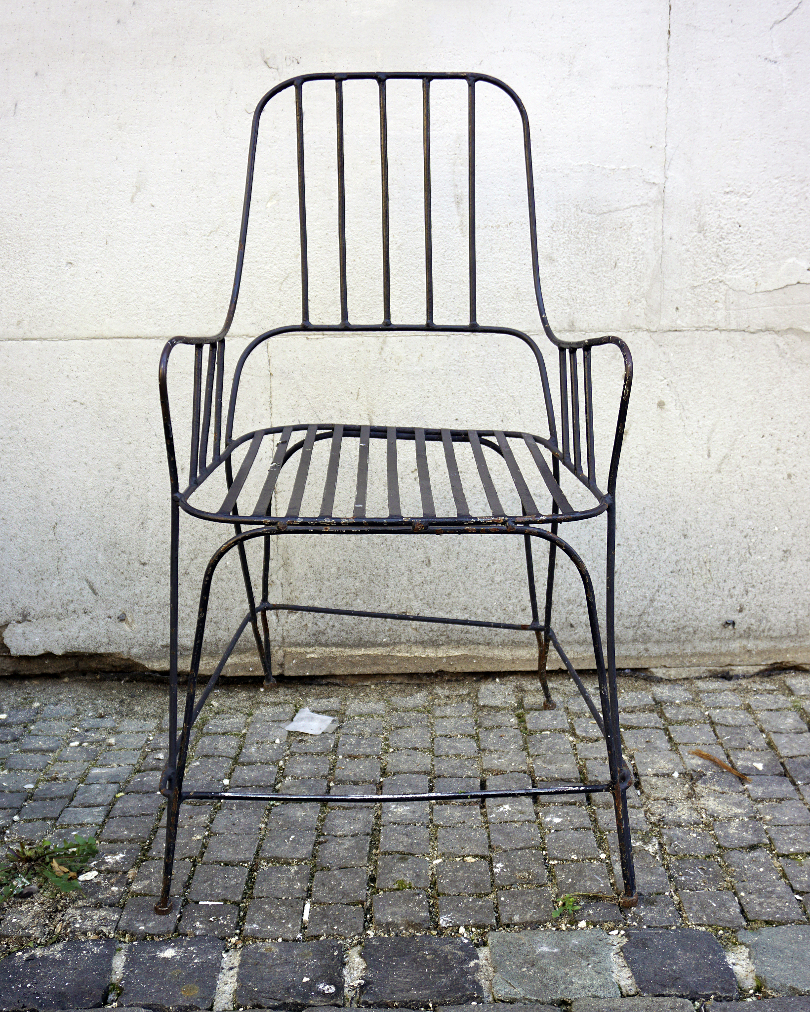 front view of black metal chair on the street. street furniture.