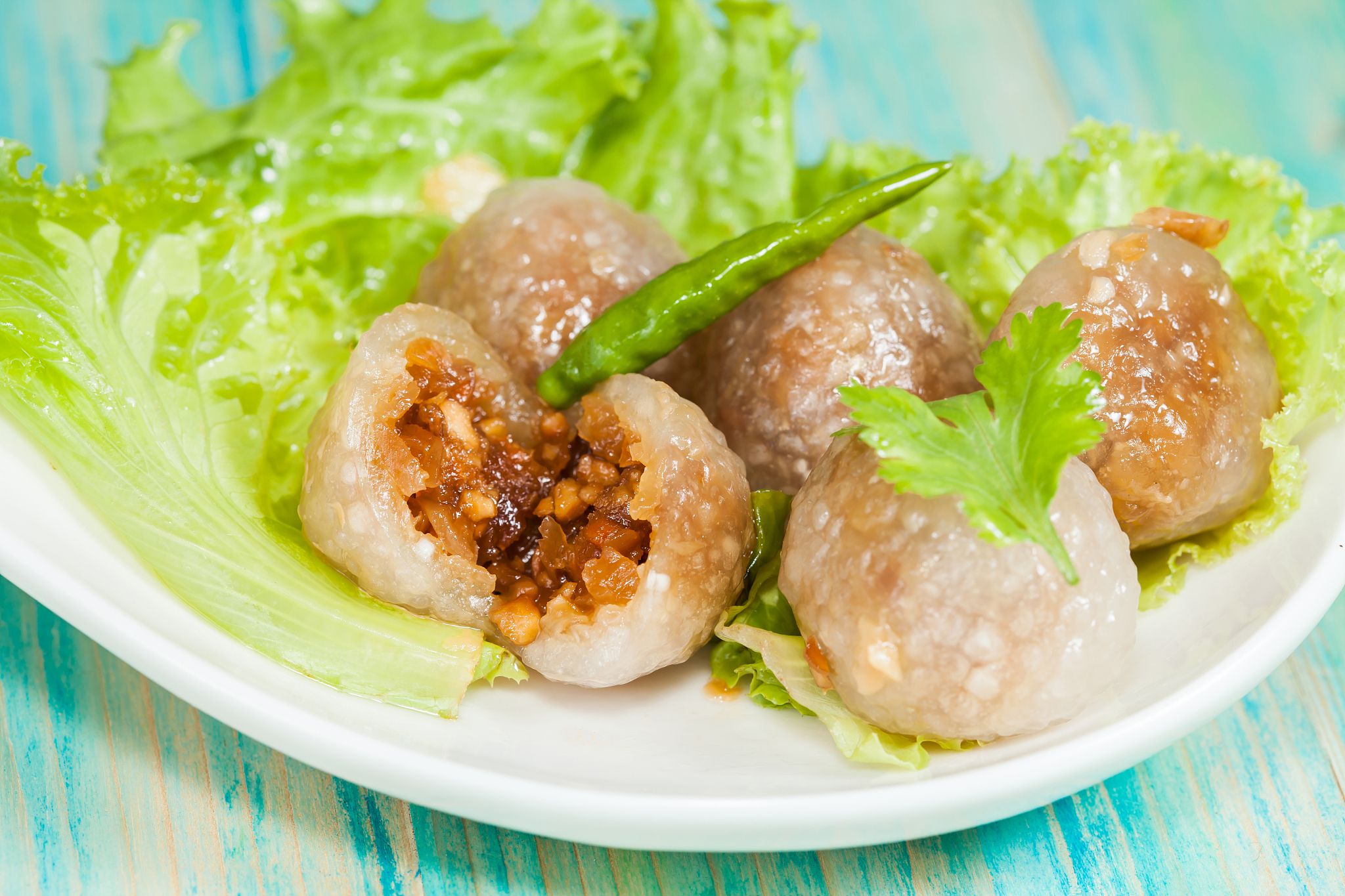 tapioca balls with pork filling and paprika on lettuce