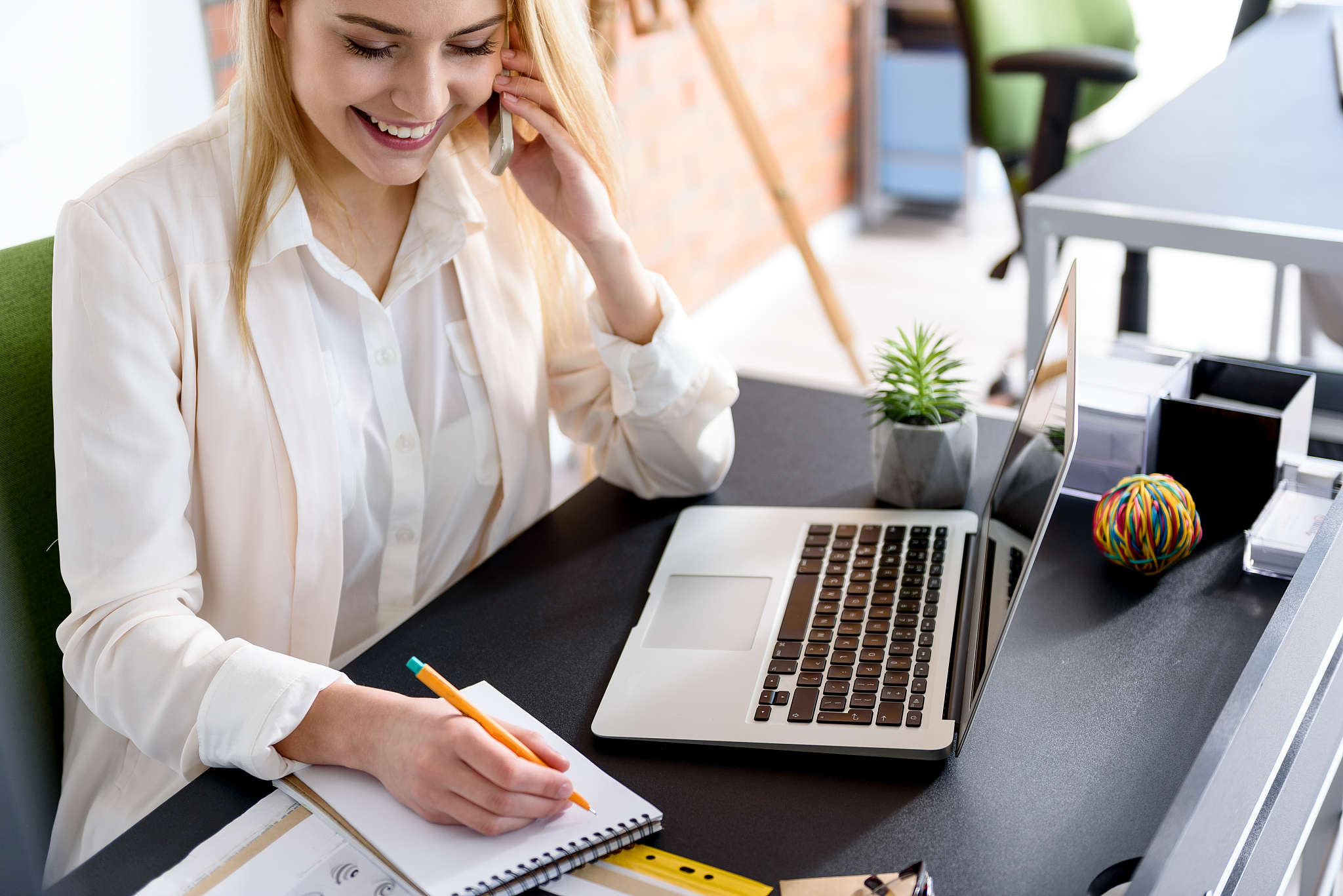 young successful girl smiling with phone in her hand
