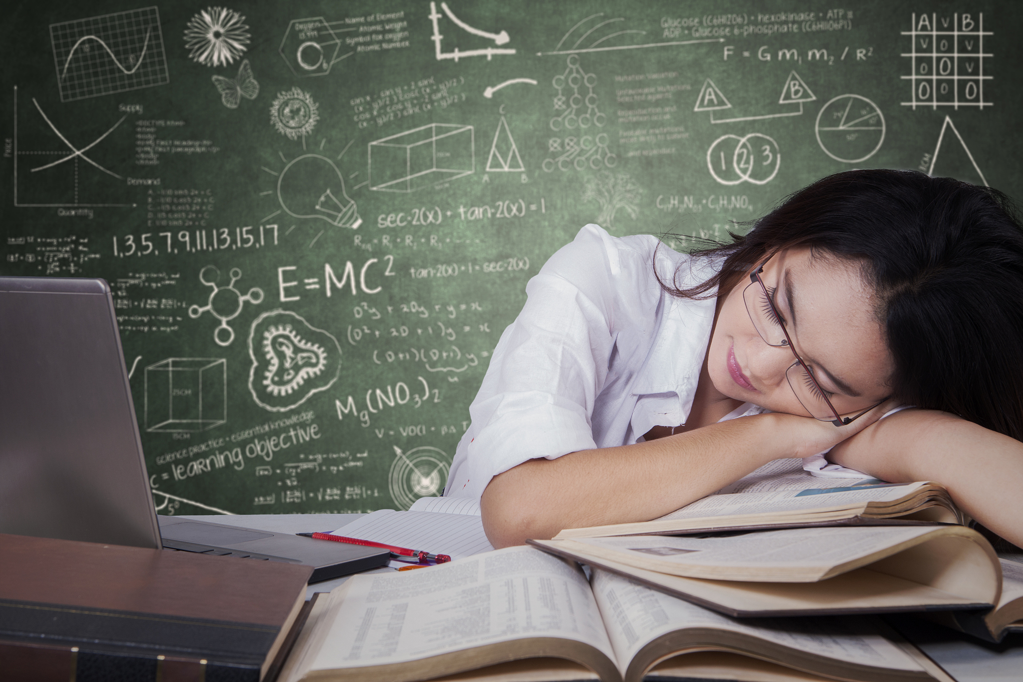 tired teenage student sleeping on desk