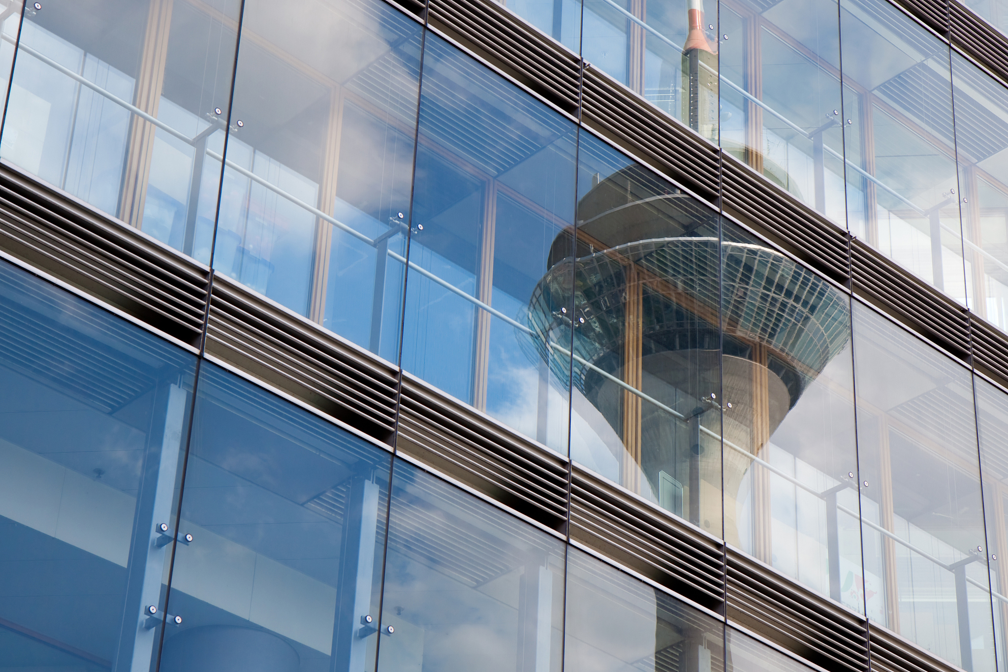 reflection of tv tower in glass facade