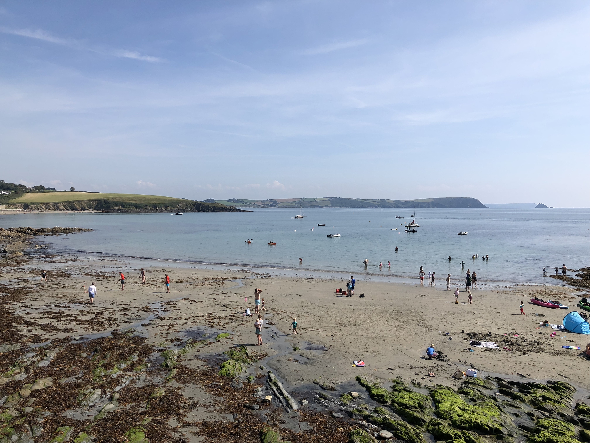 people on beach against sky