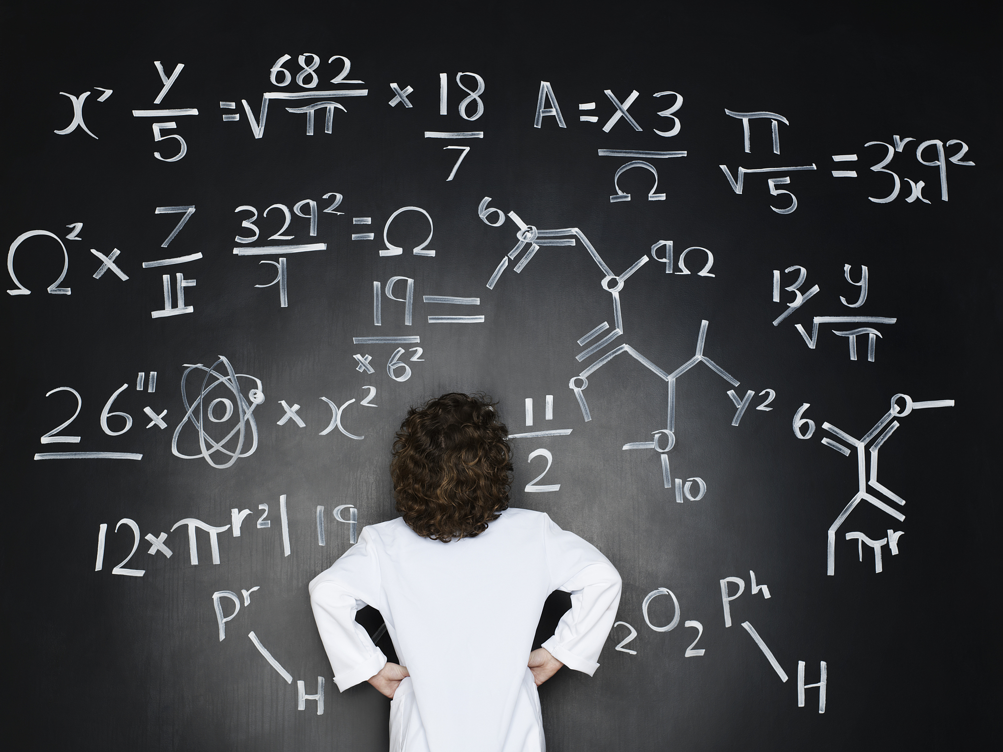 boy dressed as a professor looking at formulas