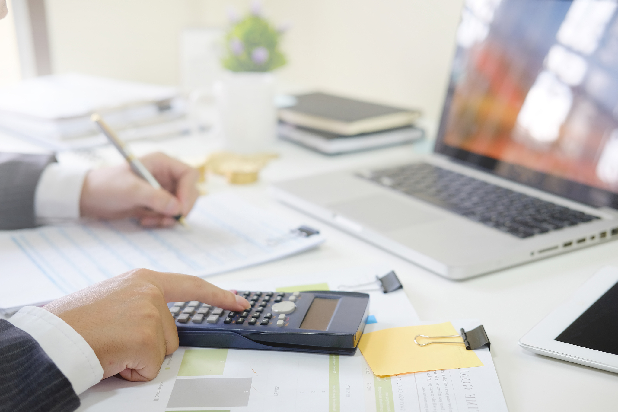 cropped shot businessman calculate financial invest on calculato