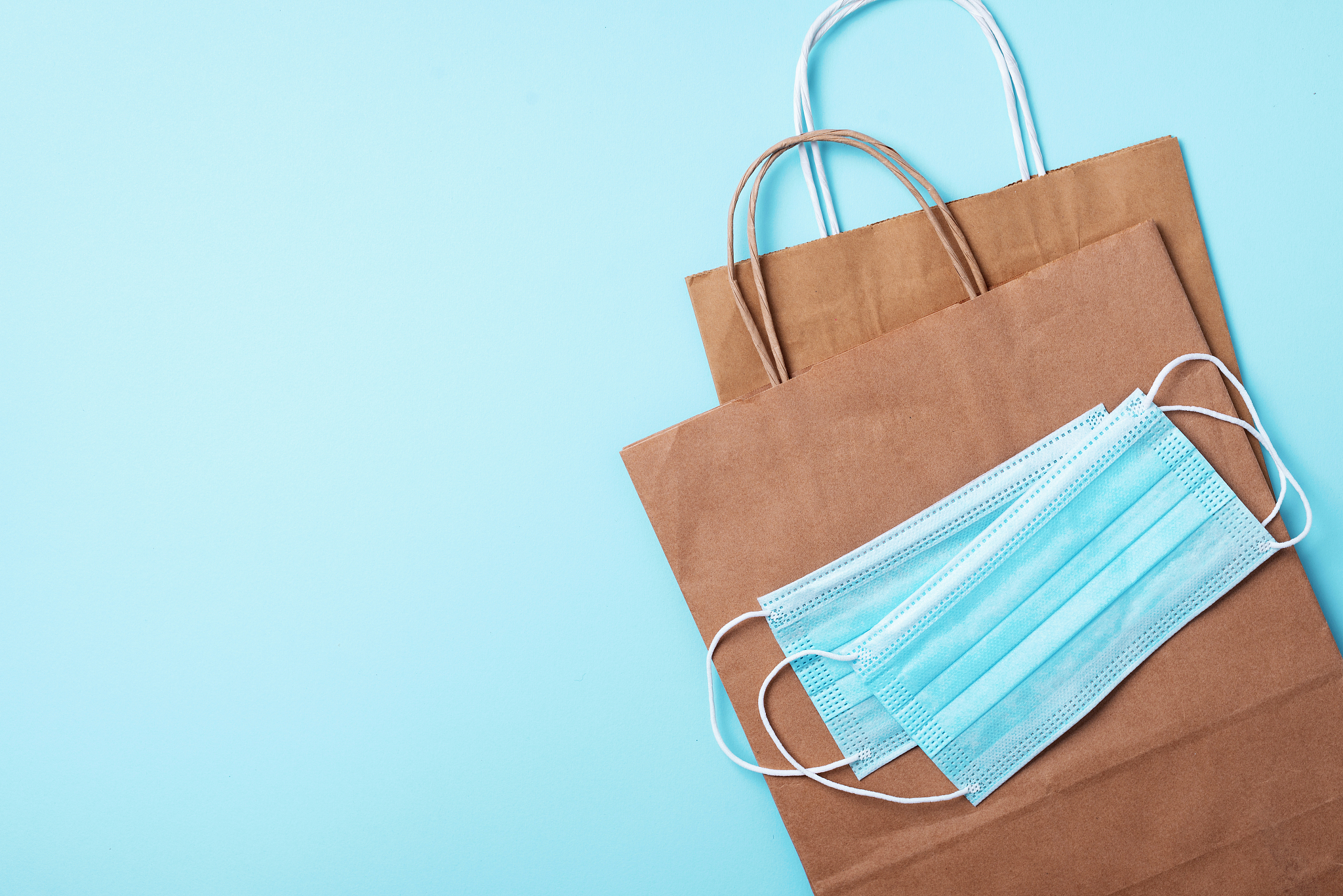 craft paper cups, food box, gloves, bags, mask on blue backgroun