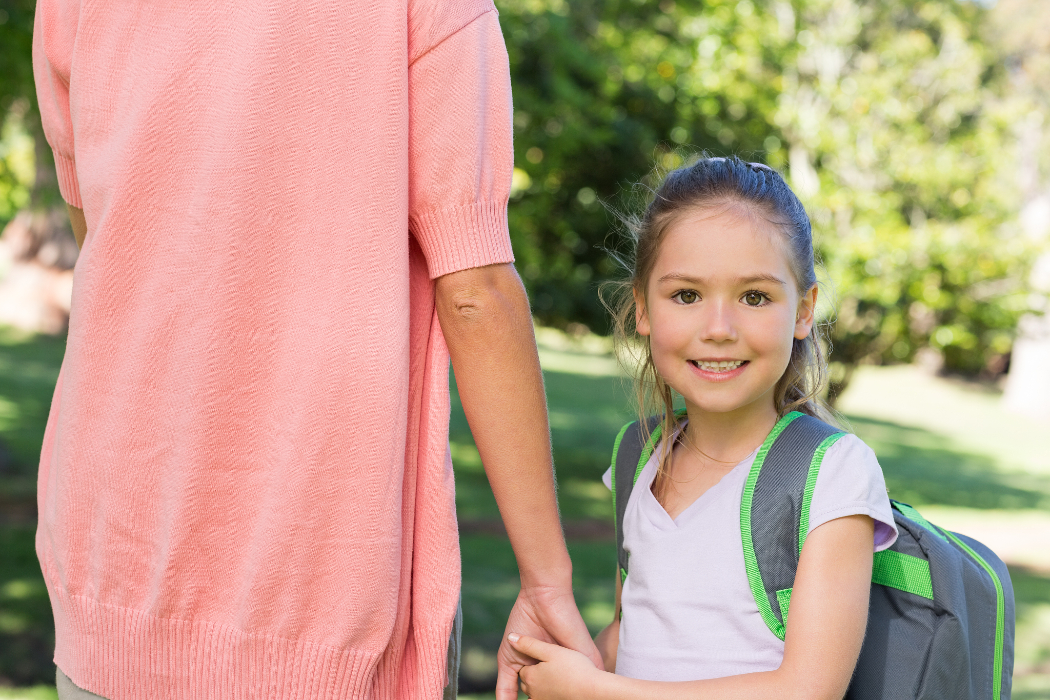happy schoolgirl with mother at park