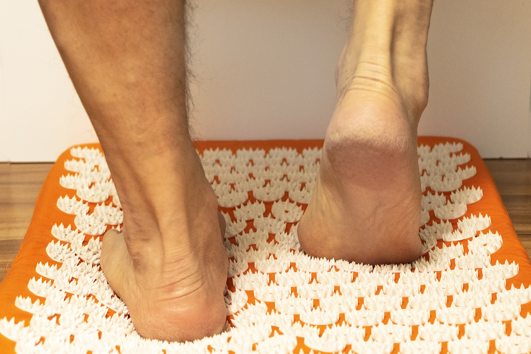 acupuncture. a man is standing on a massage mat. massage lifesty