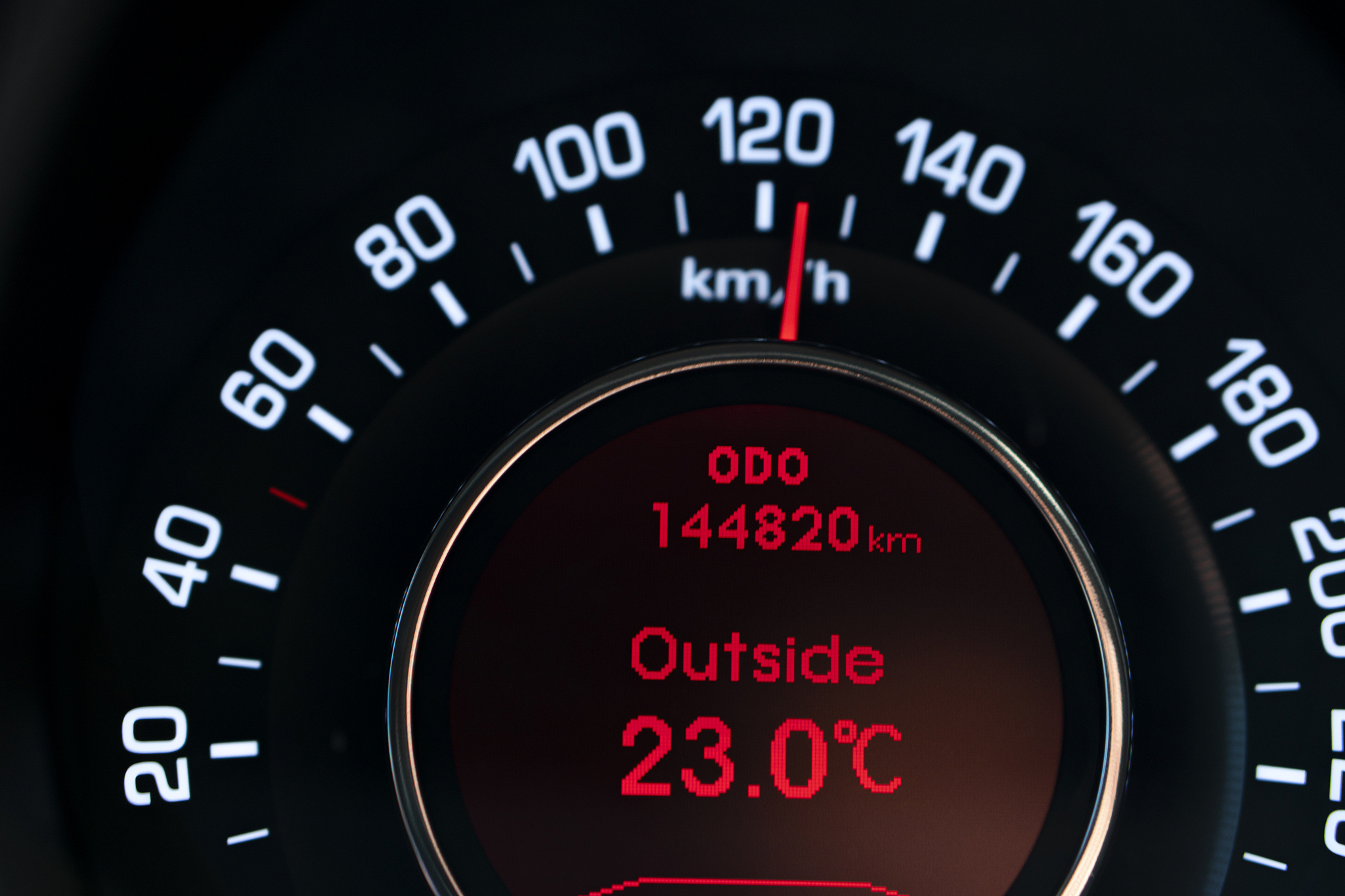close up shot of a red speedometer in a car. car dashboard. dash