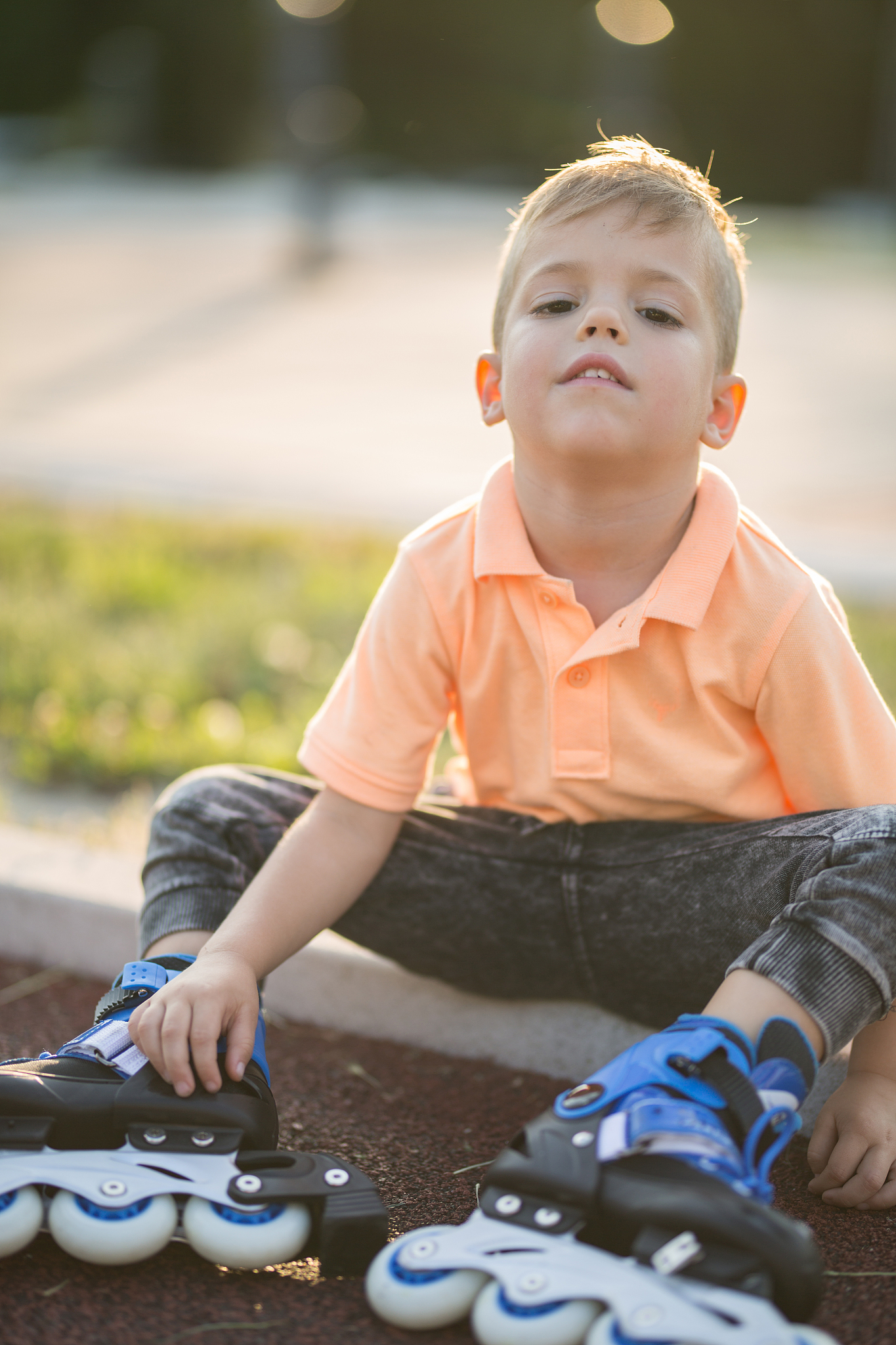 child taking a break from riding in-line skates.