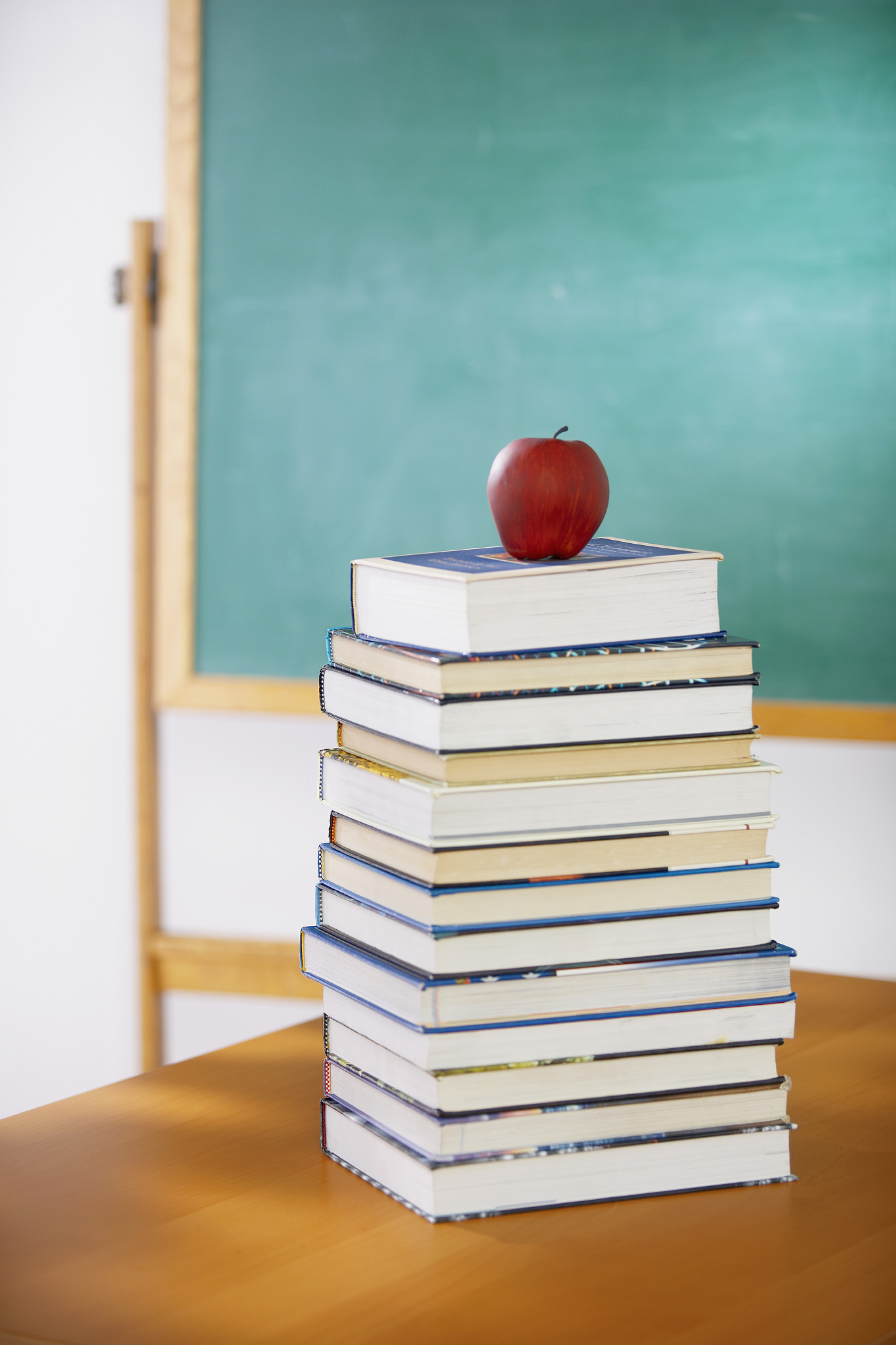 apple on top stack of books