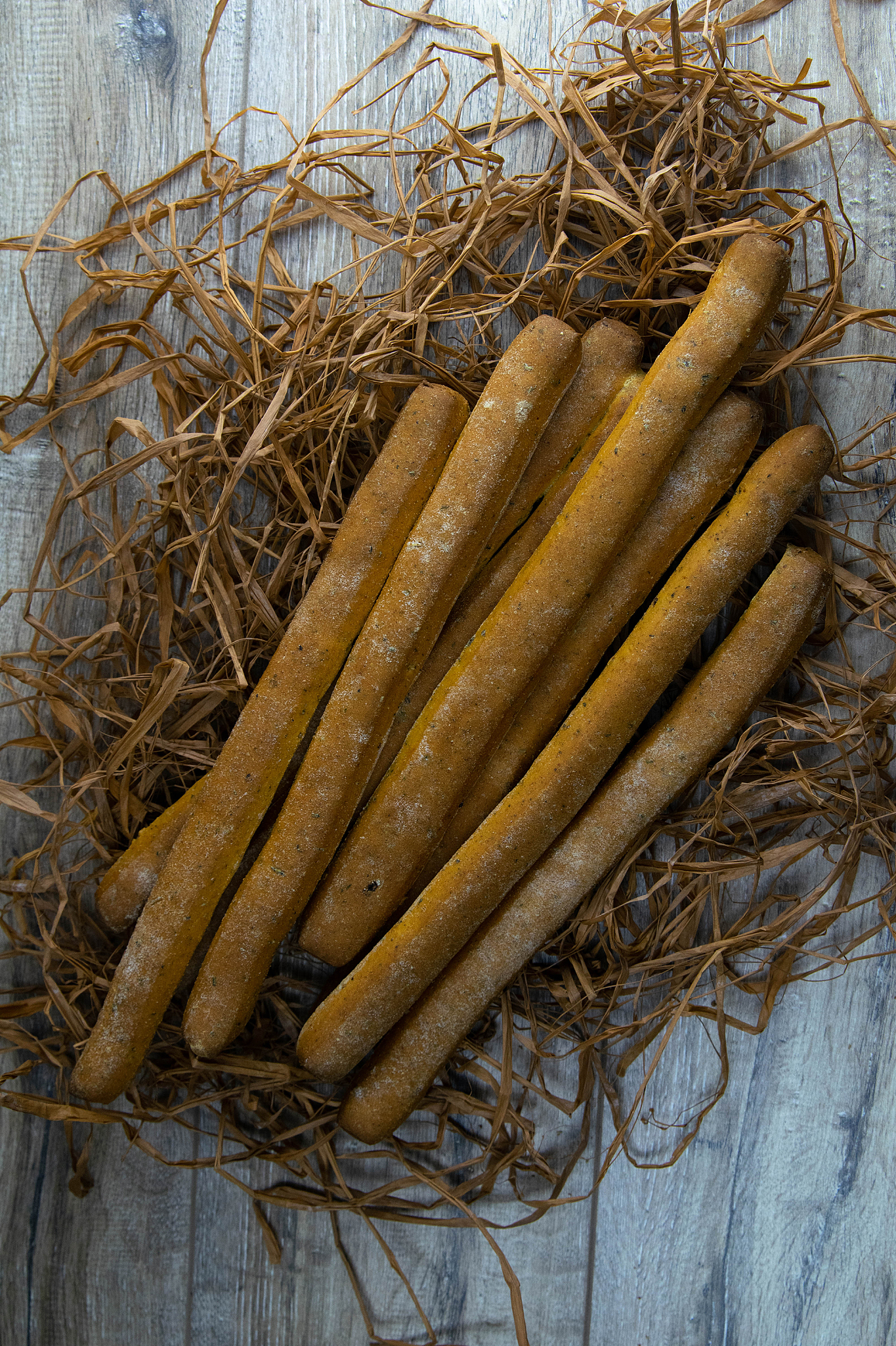 concept shot of spices bread sticks stand on dry grass