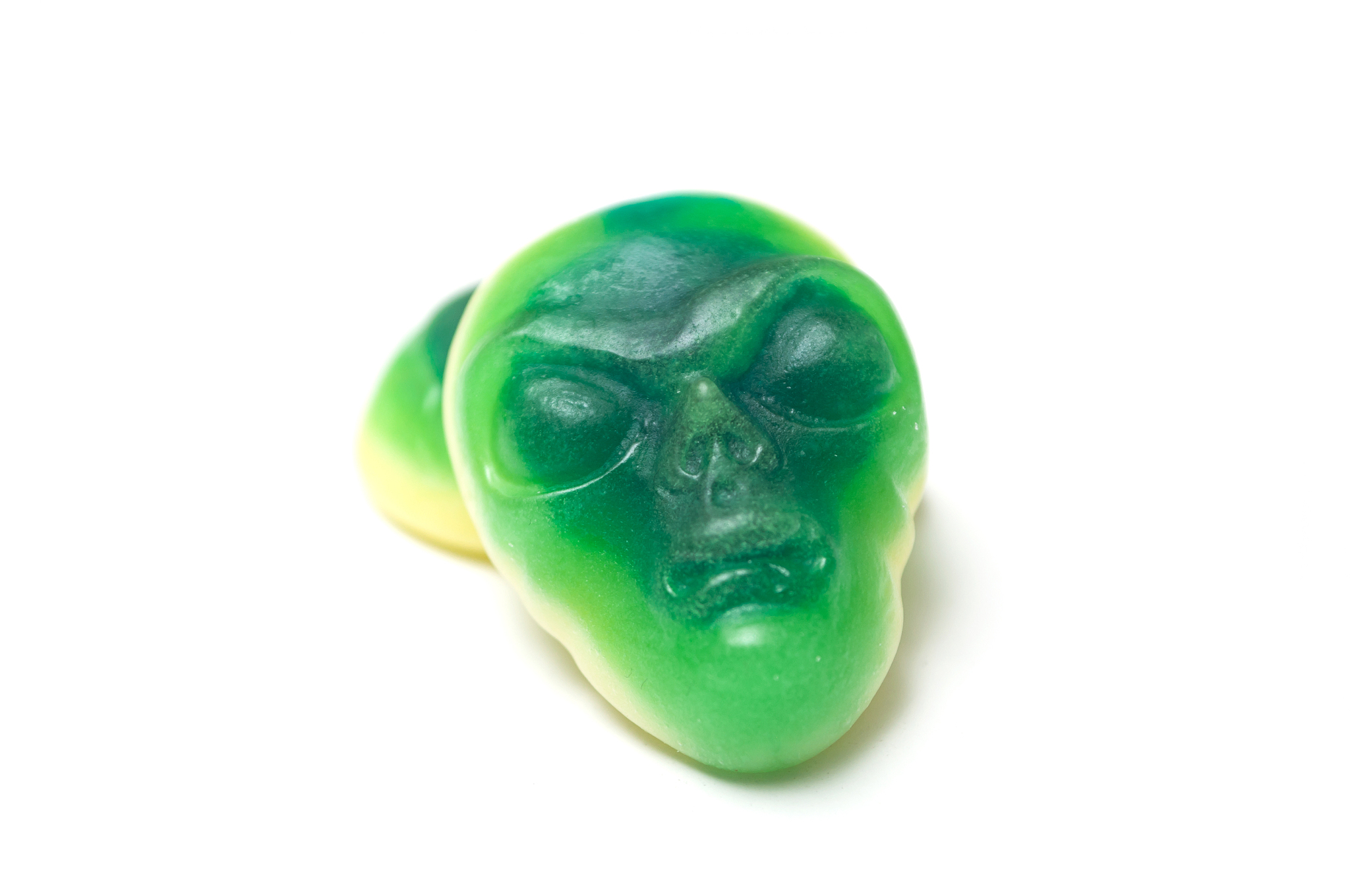 candies in shaped alien face on white background