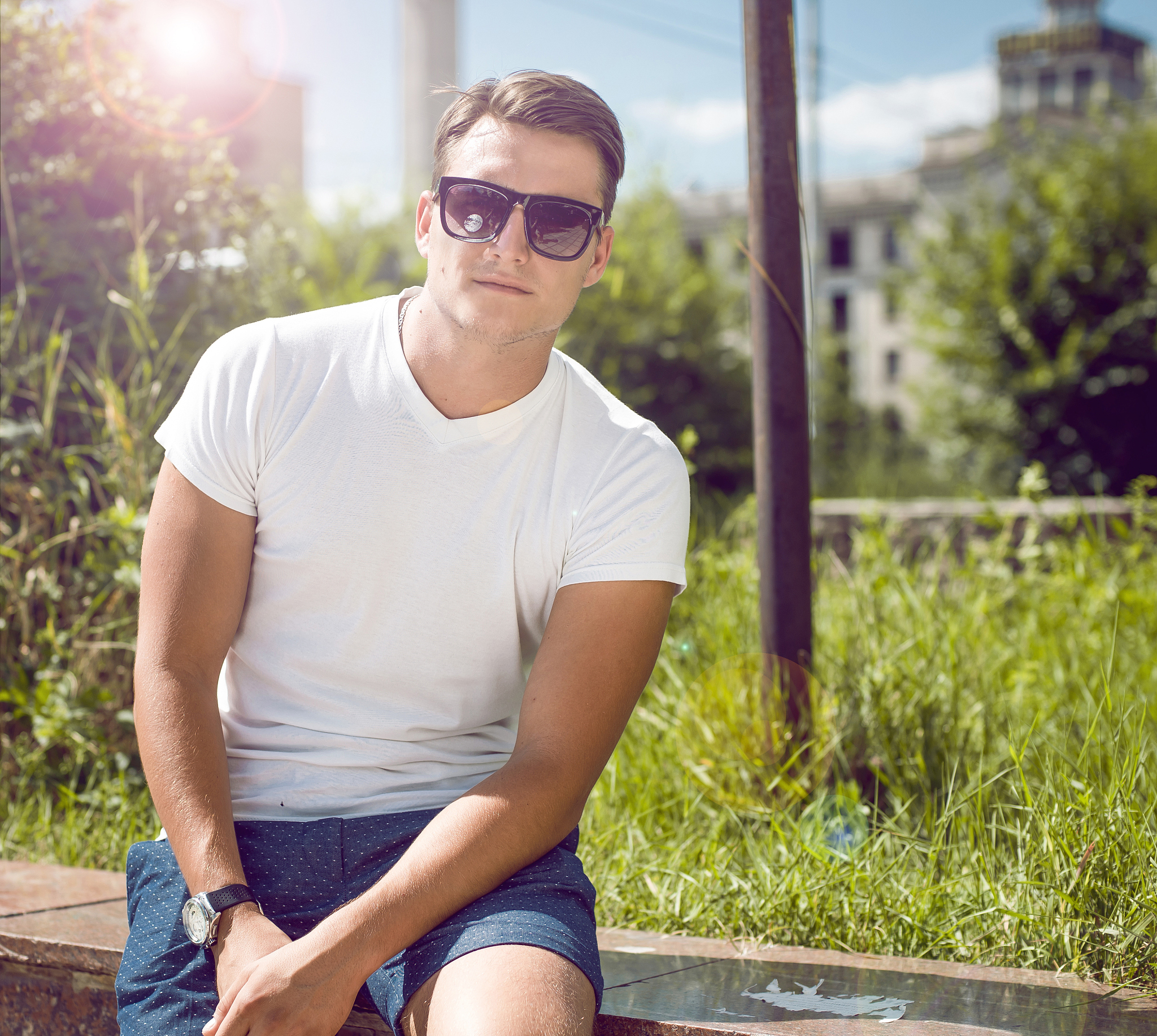 man in white shirt and dark eyeglasses on street
