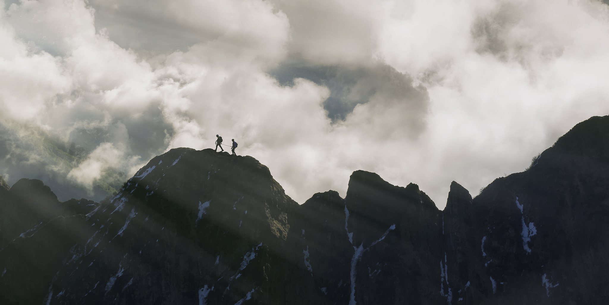 climbers on a rocky ridge.