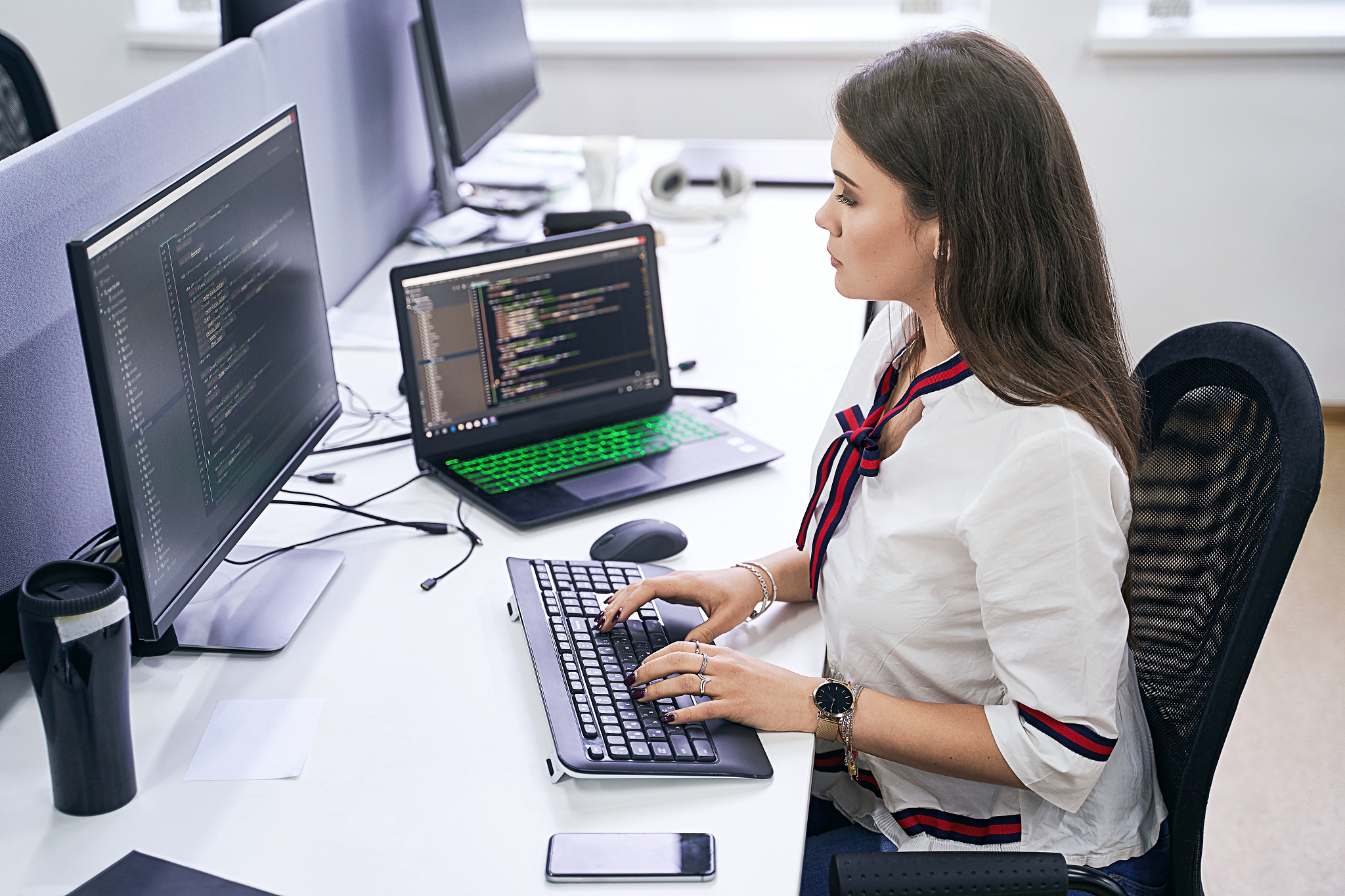 beautiful female junior software developer working on computer i