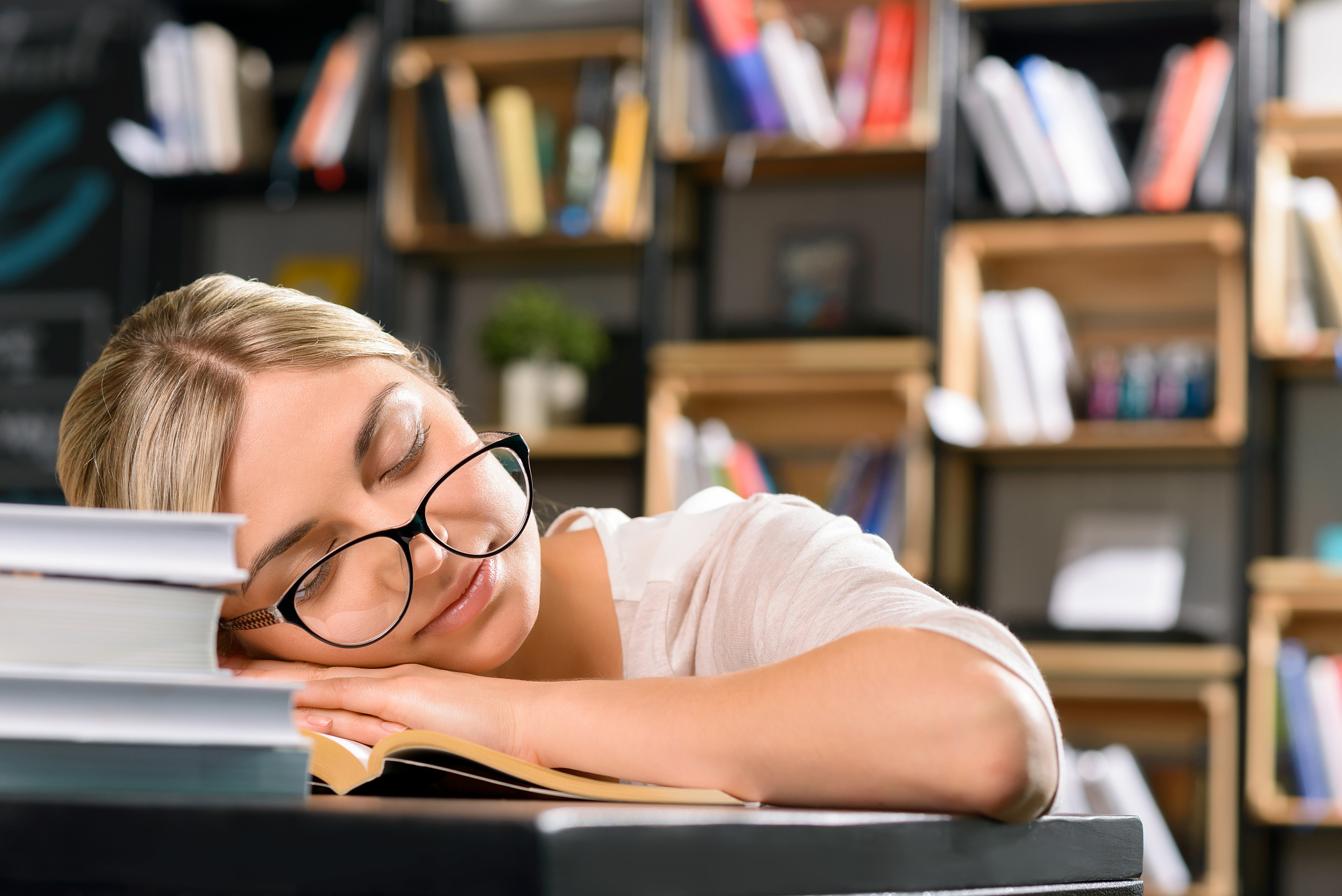 young lady falls asleep while studying