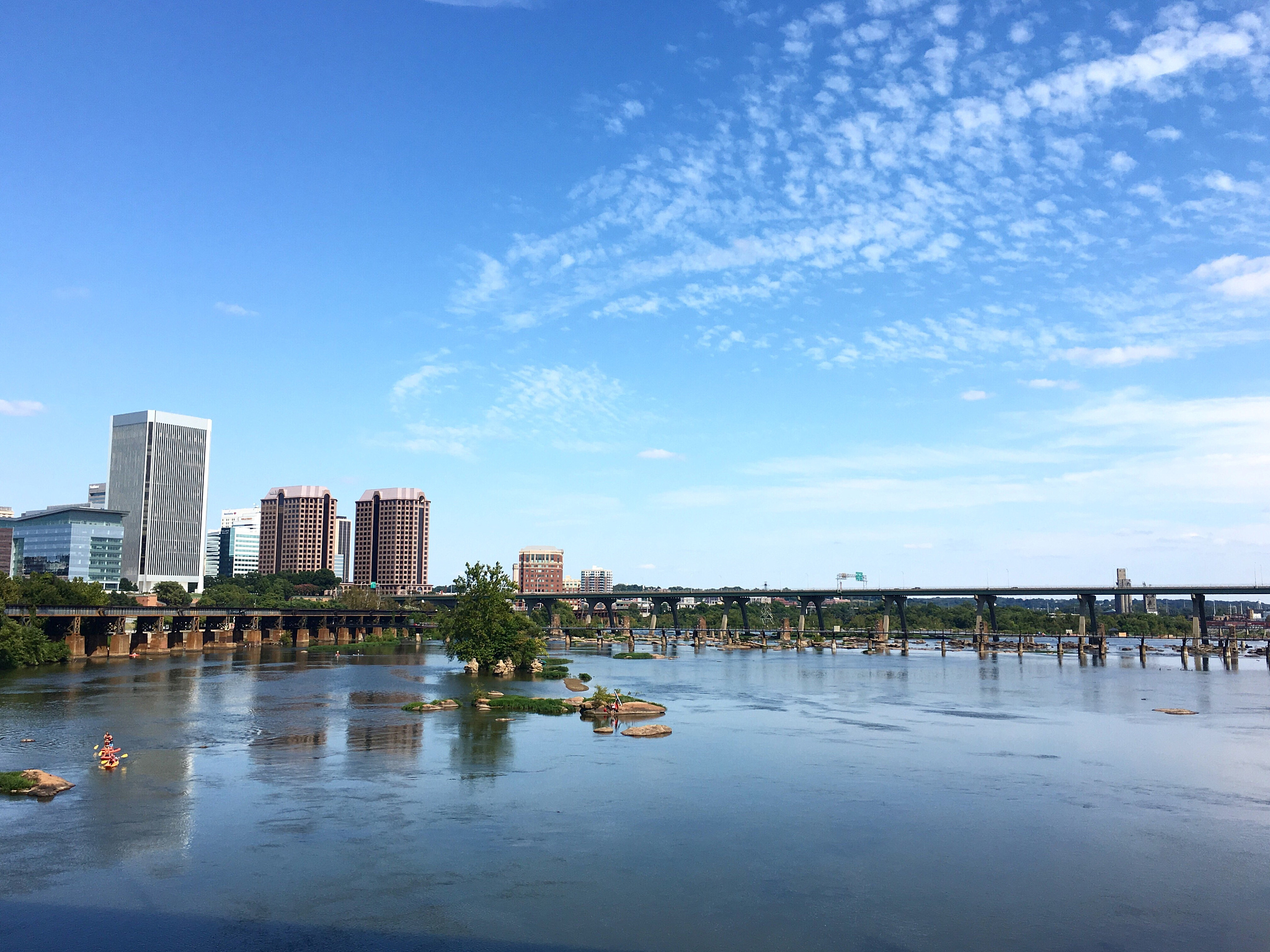 bridge over river with city in background