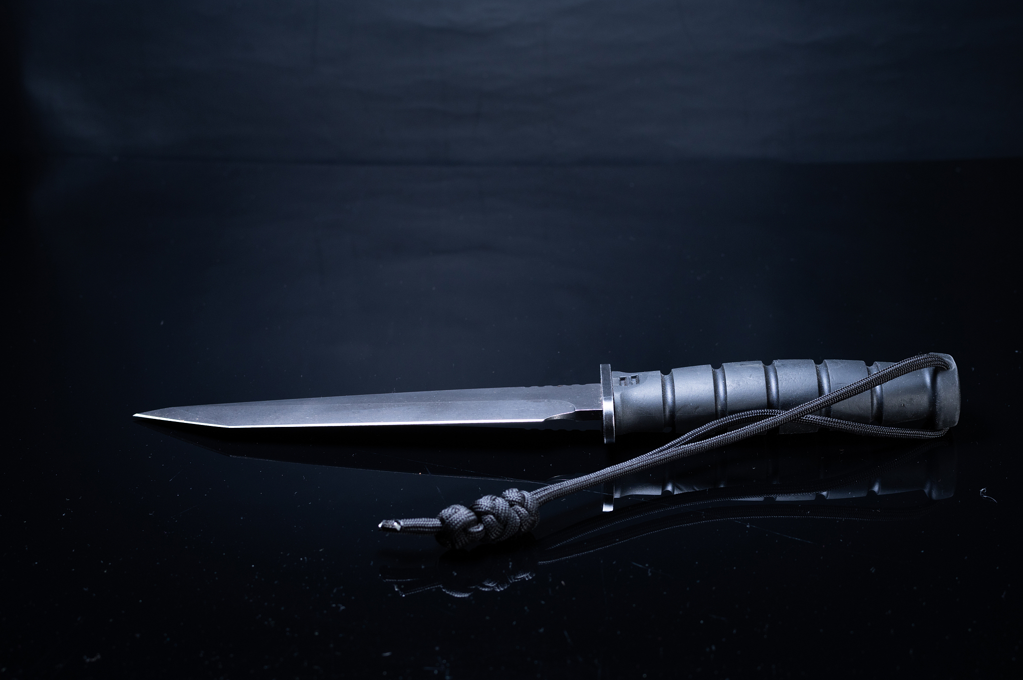 large army knife on a black background. black knife on a black f