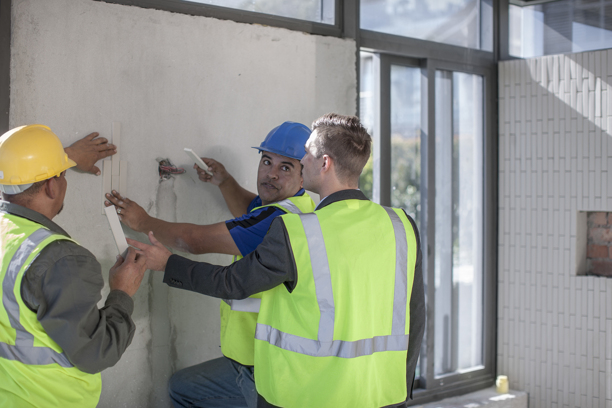 architect and construction workers on construction site