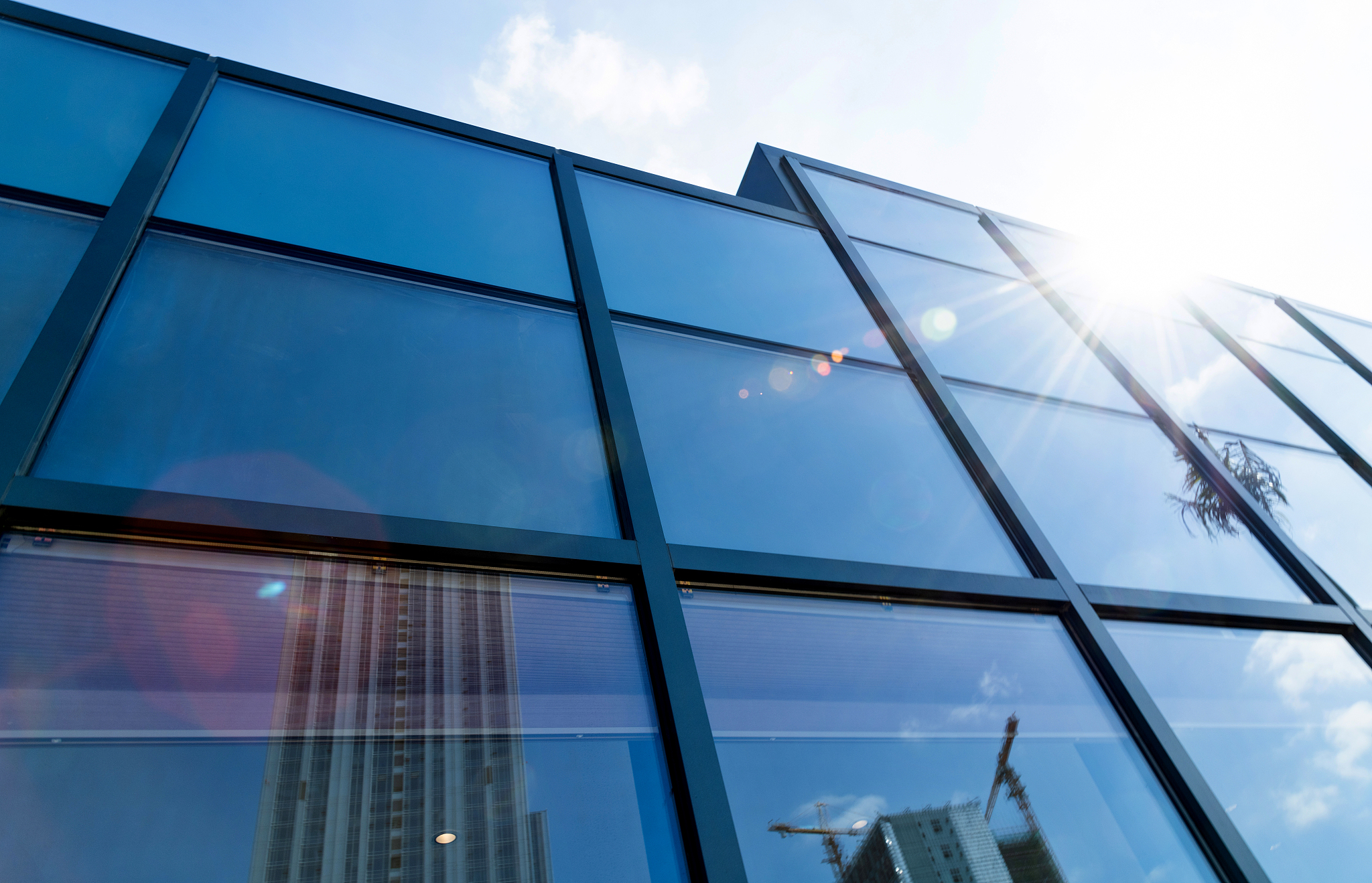 construction site reflected on glass windows of modern building