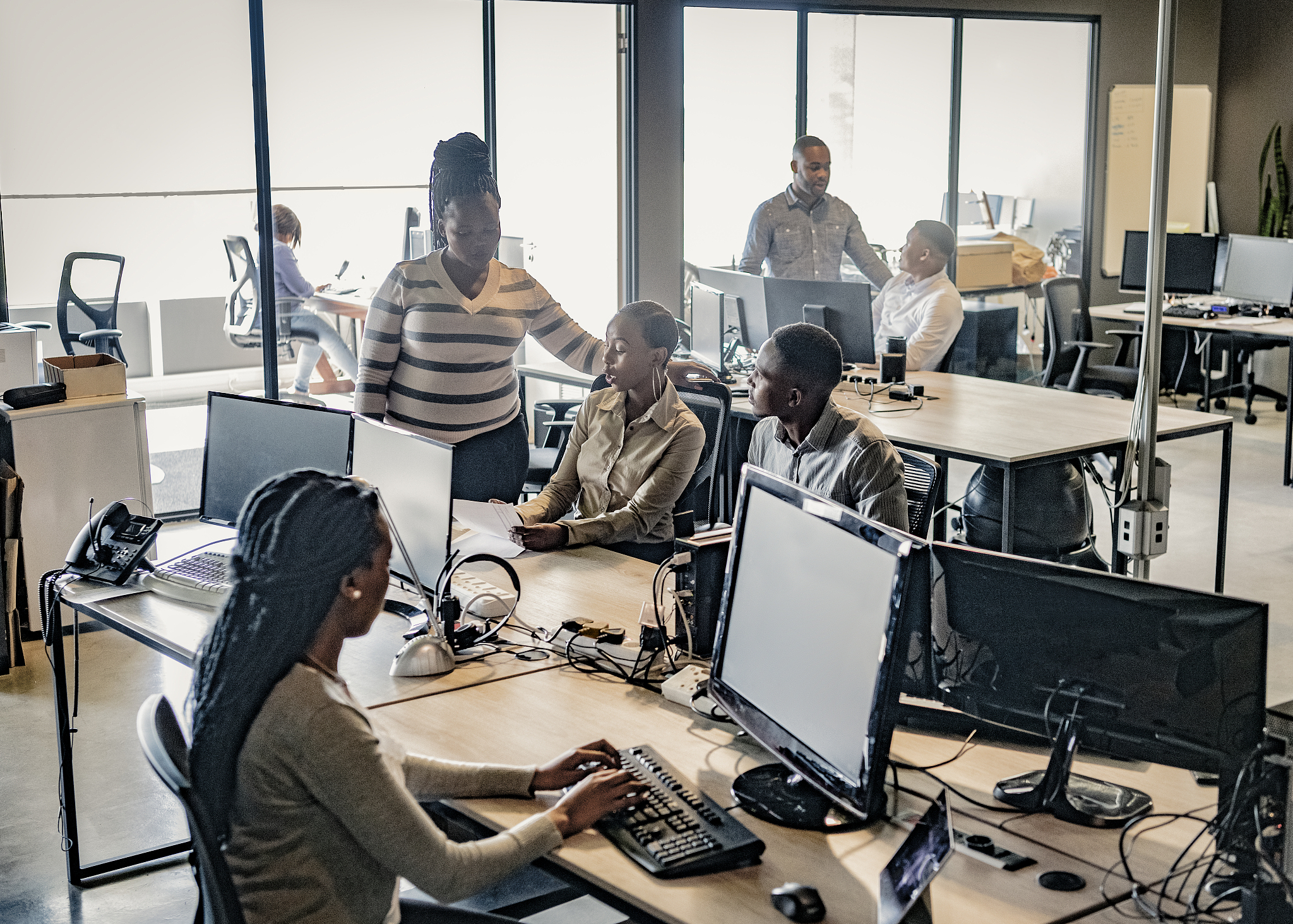 business people working on computers in busy office