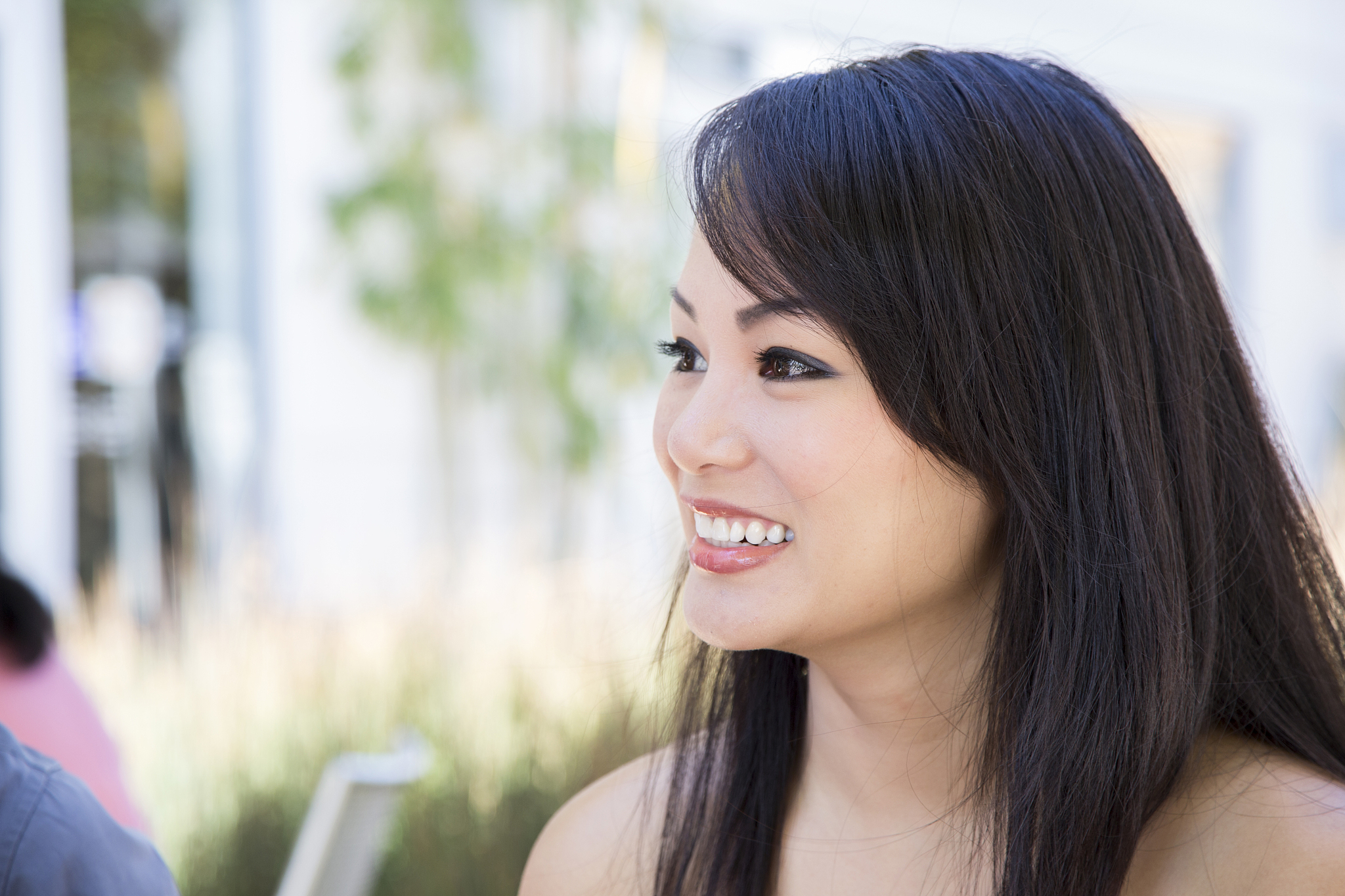 profile of asian beauty at an outdoor cafe