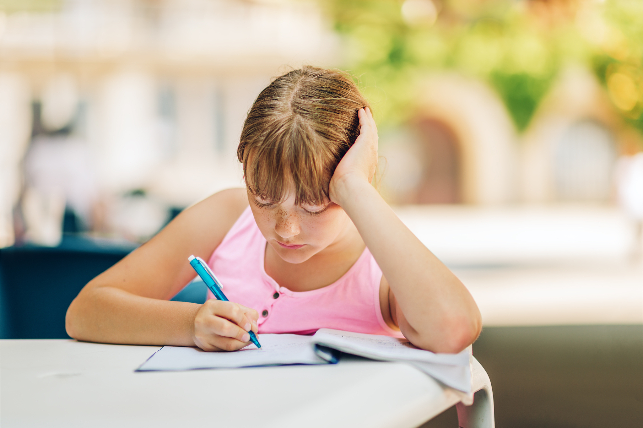 cute kid girl doing school homework outside, home schooling, edu