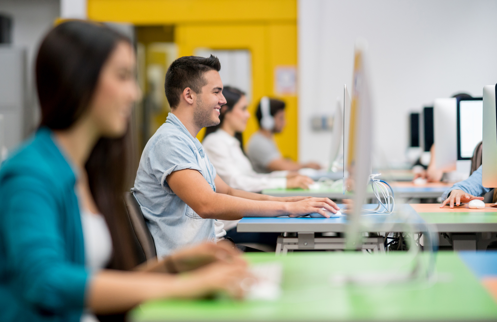 happy student in an it class using computer