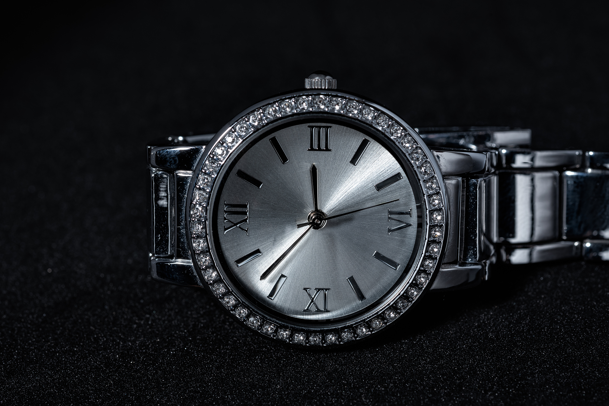 close-up of wristwatch on black background