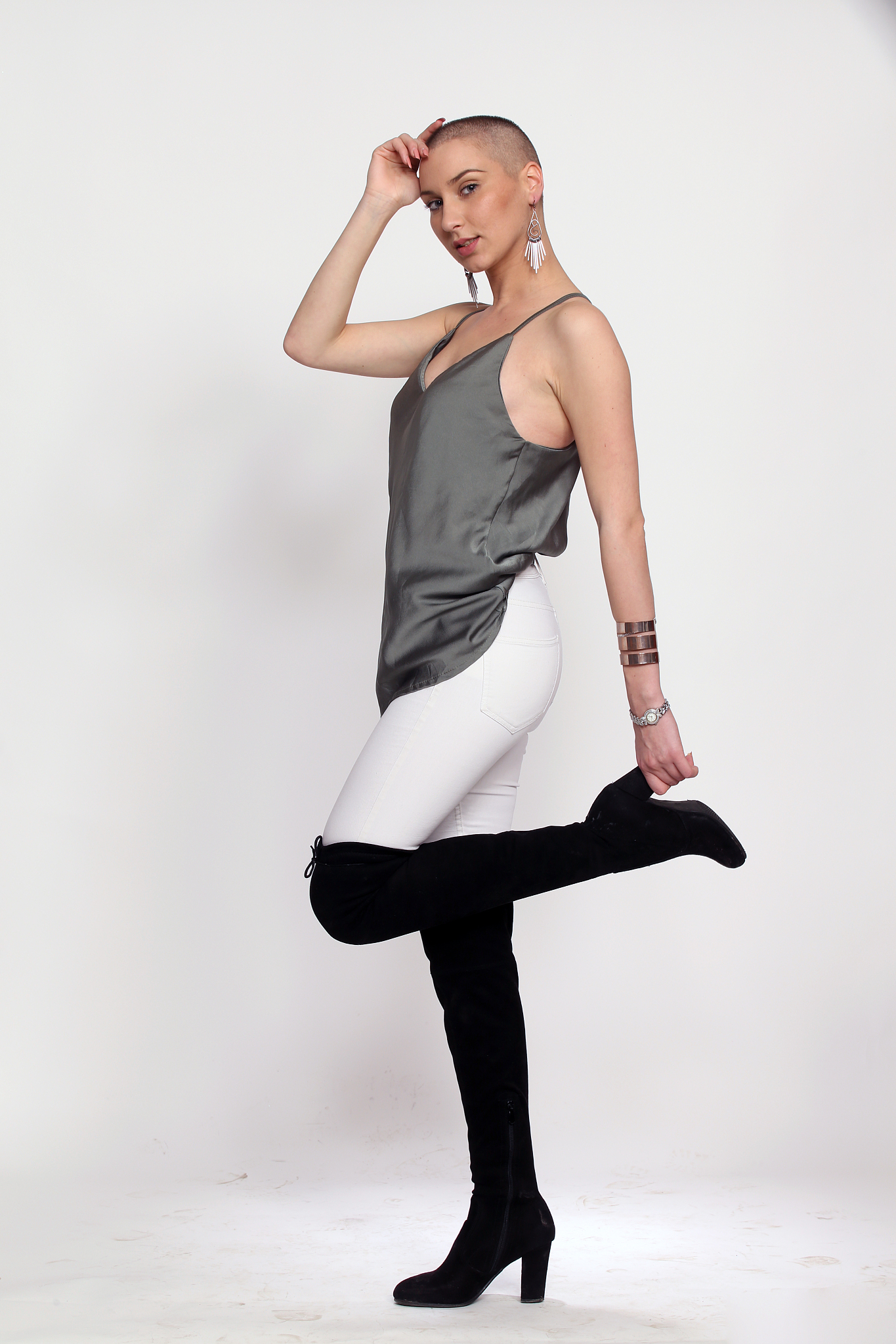 glamorous, attractive girl with short hair is posing in studio o