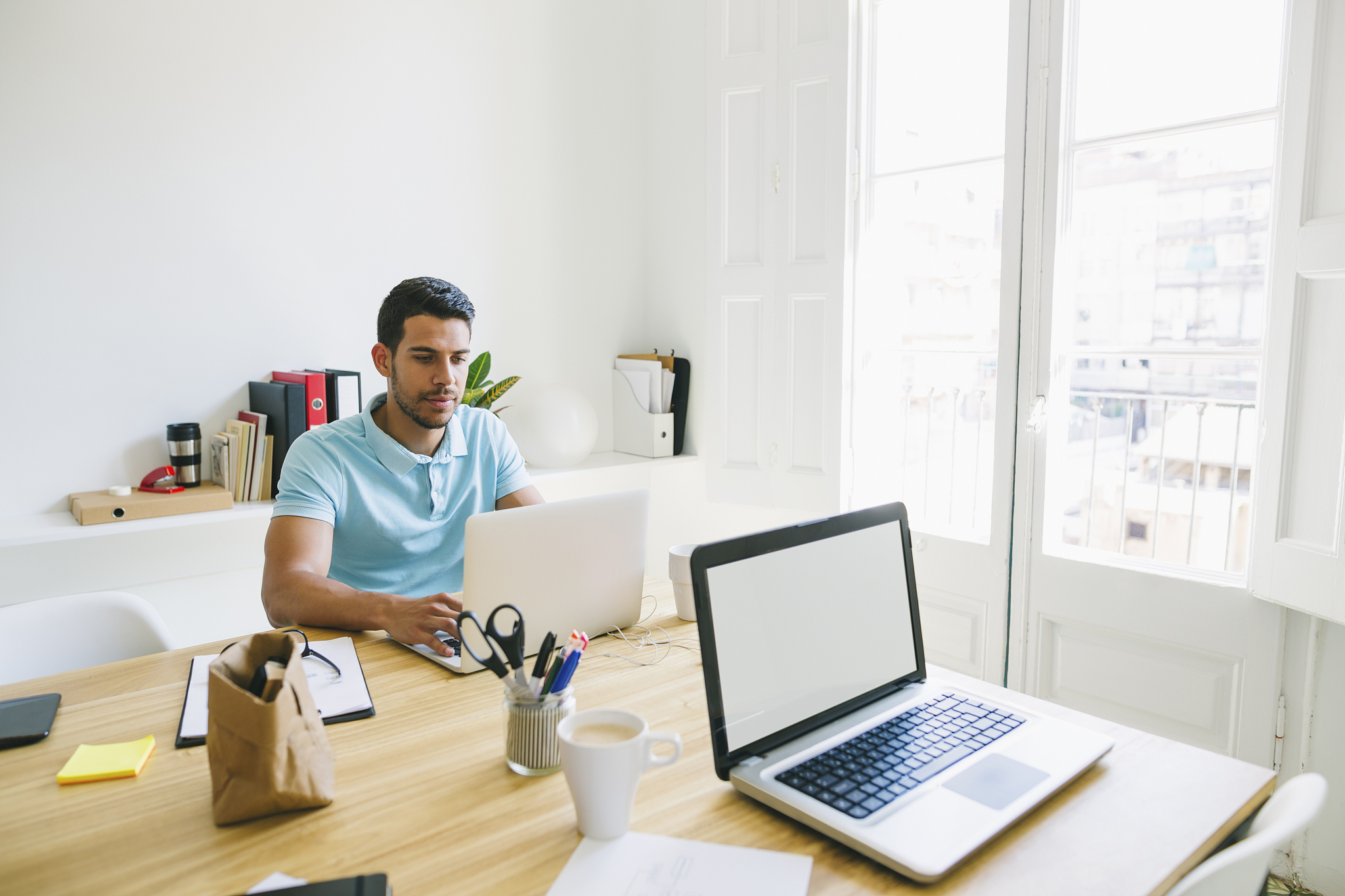 young man working in office, using laptop