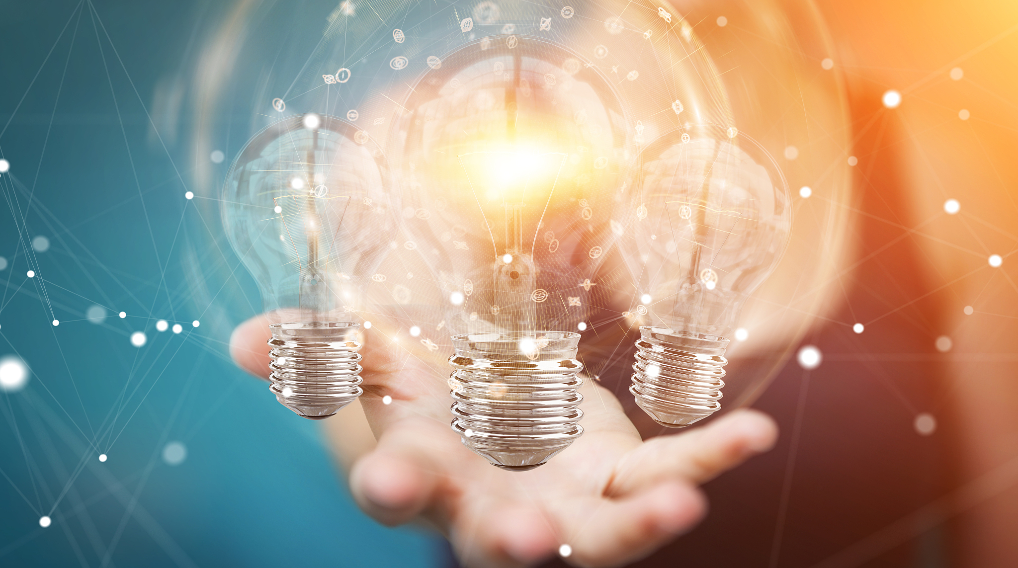 businesswoman on blurred background connecting modern lightbulbs