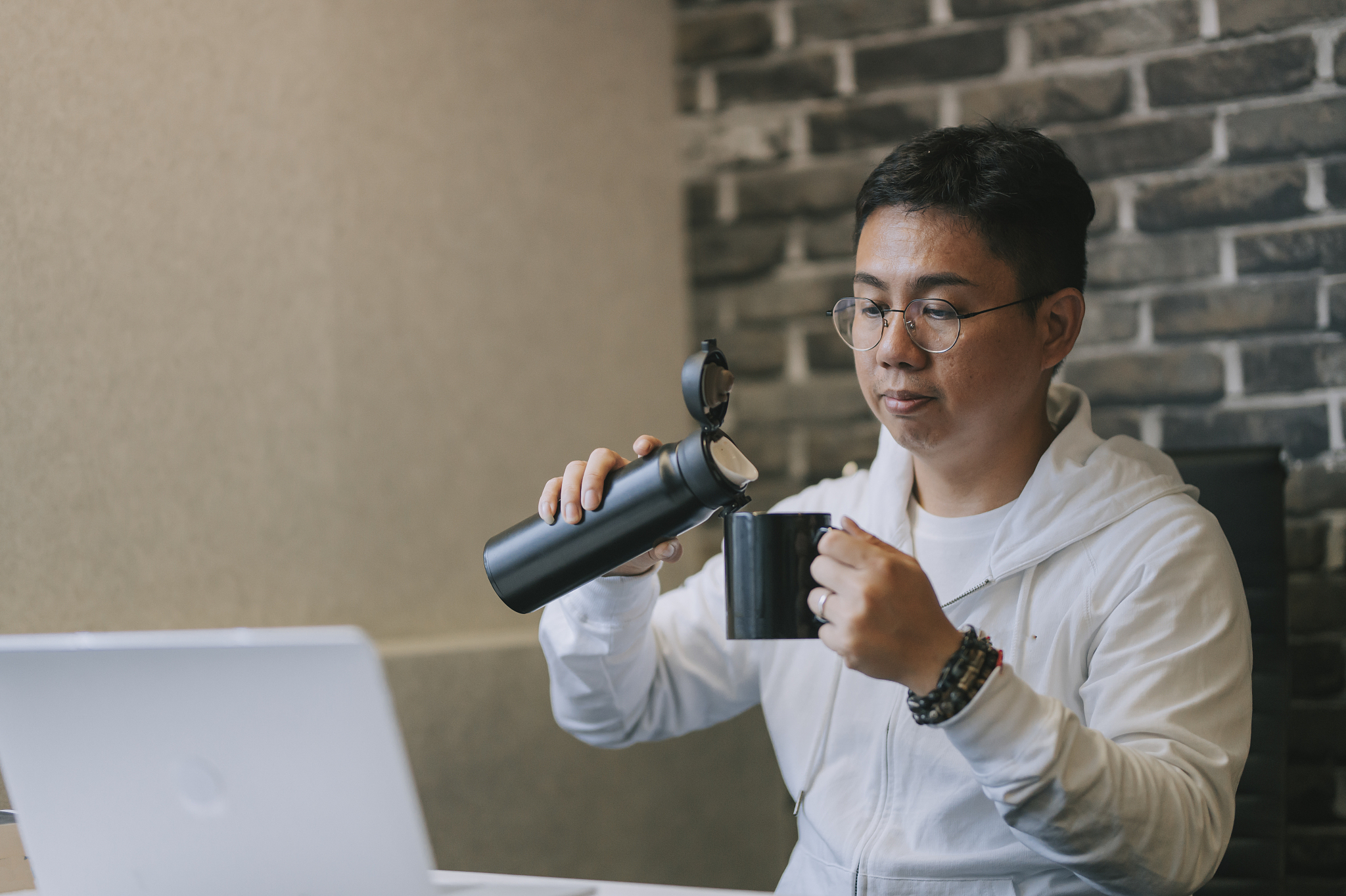 an asian chinese mid adult man taking a break in his office room