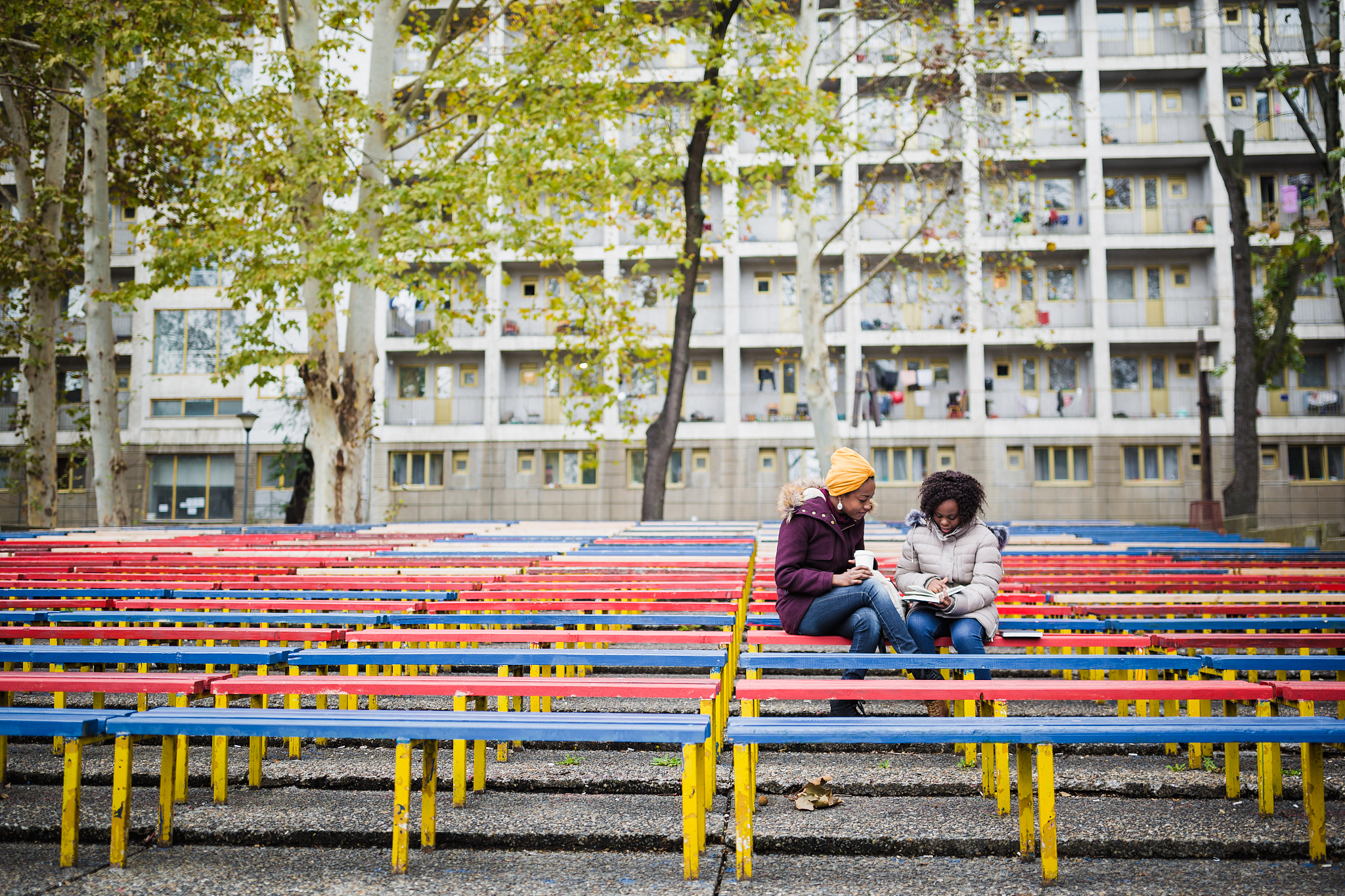 two girlfriends, students on a coffee break, outdoors