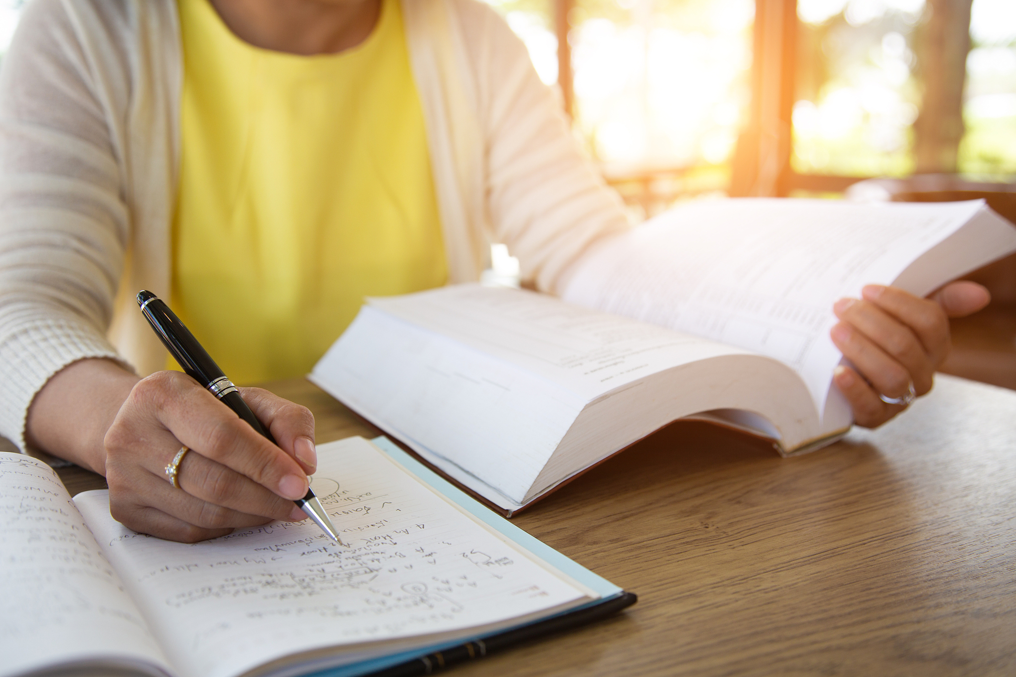 business women are studying the book in order to plan the market