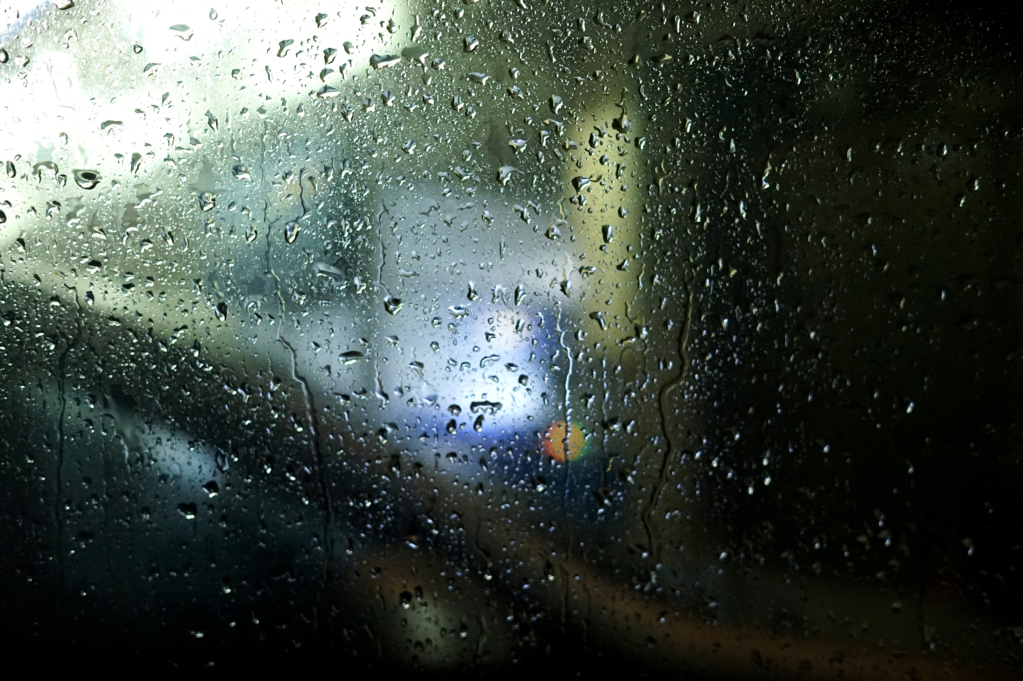 city street. rainy night, raindrops. vehicles, tail lights. wind