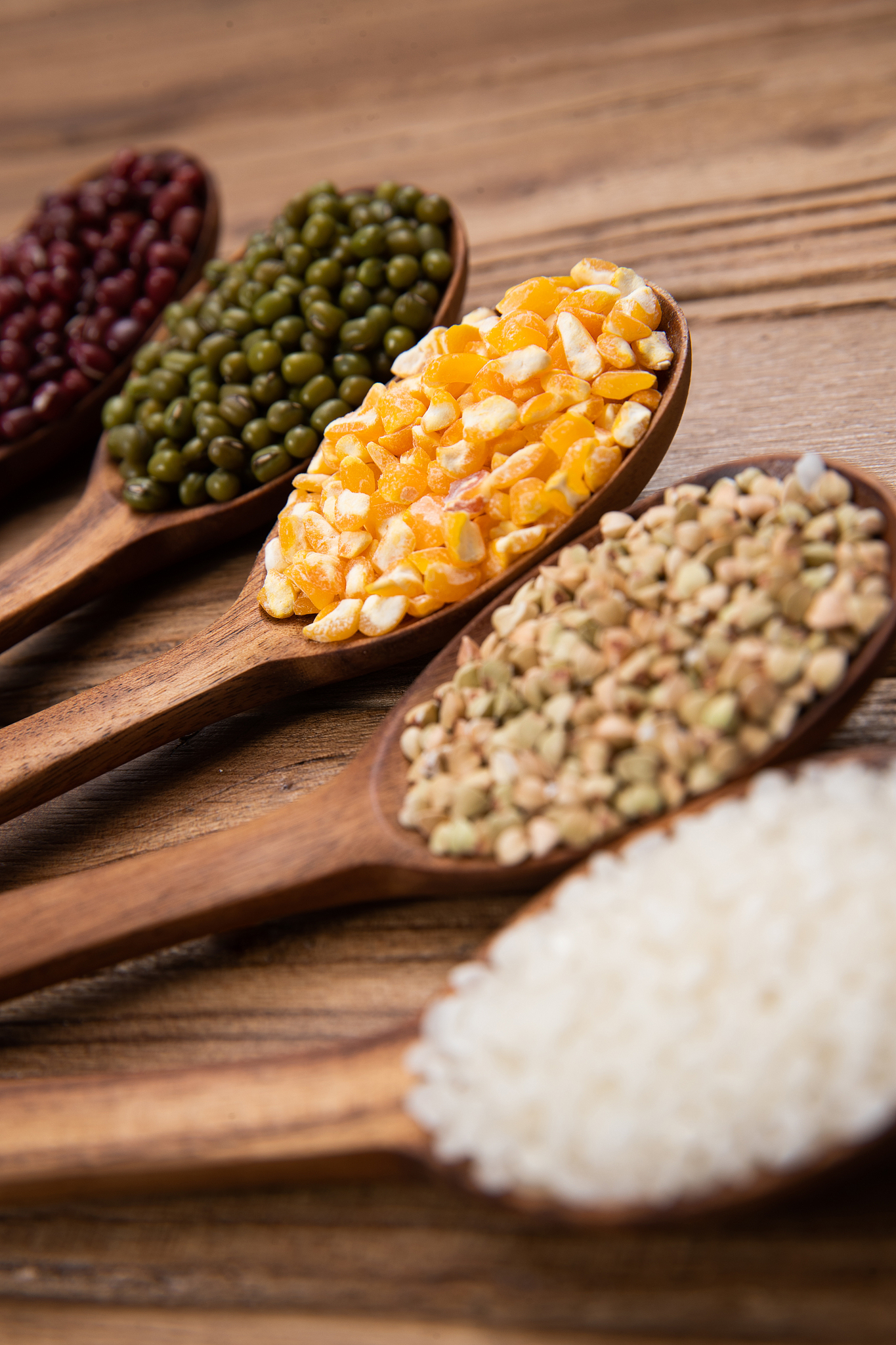 wooden spoon is filled with grain